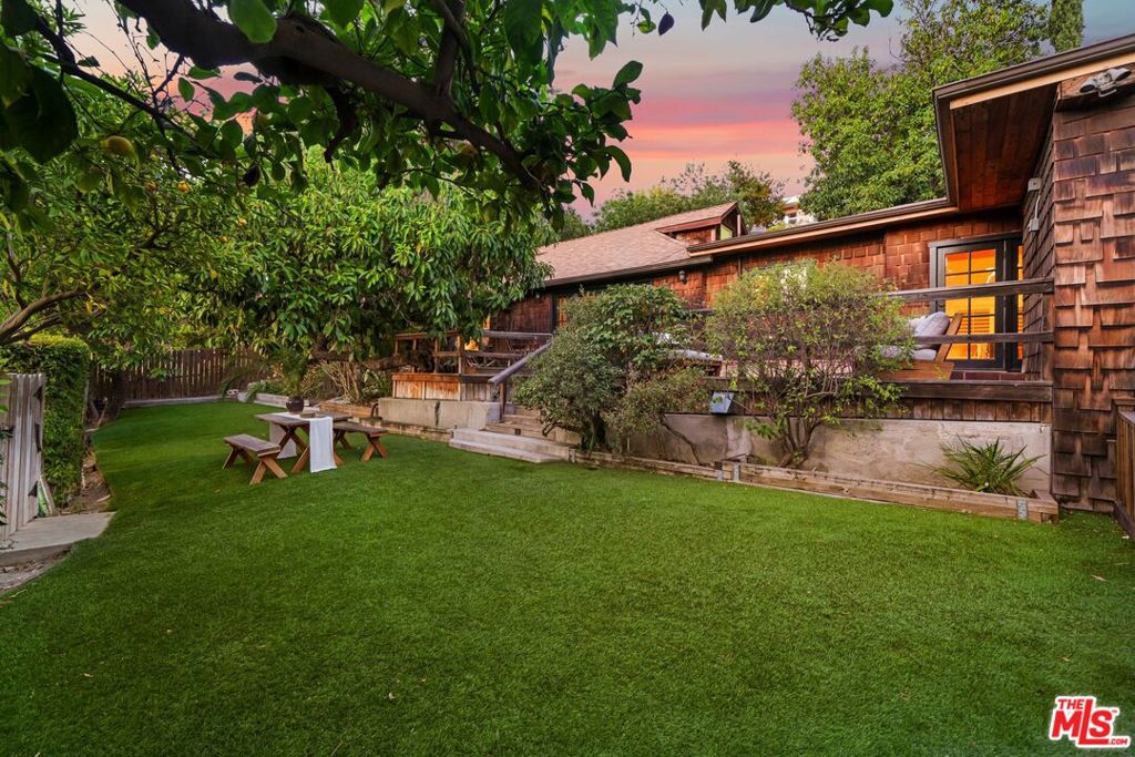 This is the perfect Artist Retreat! Set on an expansive 13,530 sq ft lot with sweeping views of Highland Park, this secluded and charming retreat offers the perfect blend of original character and thoughtful upgrades. Surrounded by mature fruit trees including avocado, lemon, and orange and lush landscaping, the property feels like a peaceful garden escape in the heart of the city. The main home features 3 spacious bedrooms and 2.5 updated bathrooms, a bright living room with a new ceiling, a modern kitchen, and both formal and casual dining areas. Recent upgrades include brand new flooring throughout, a new HVAC system, a new roof on the main house and bedroom, and a bolstered foundation, offering peace of mind and long-term value. Large sliding doors lead out to an expansive wooden deck and beautifully manicured yard, perfect for entertaining or enjoying the hillside scenery. The property's detached 1-bedroom, 1-bathroom guest house provides versatile options ideal for guests, a home office, or creative studio space. Move right in and fall in love with this beautiful rare property. Just minutes from York and Figueroa, the best best shops, cafes, and restaurants in Highland Park.