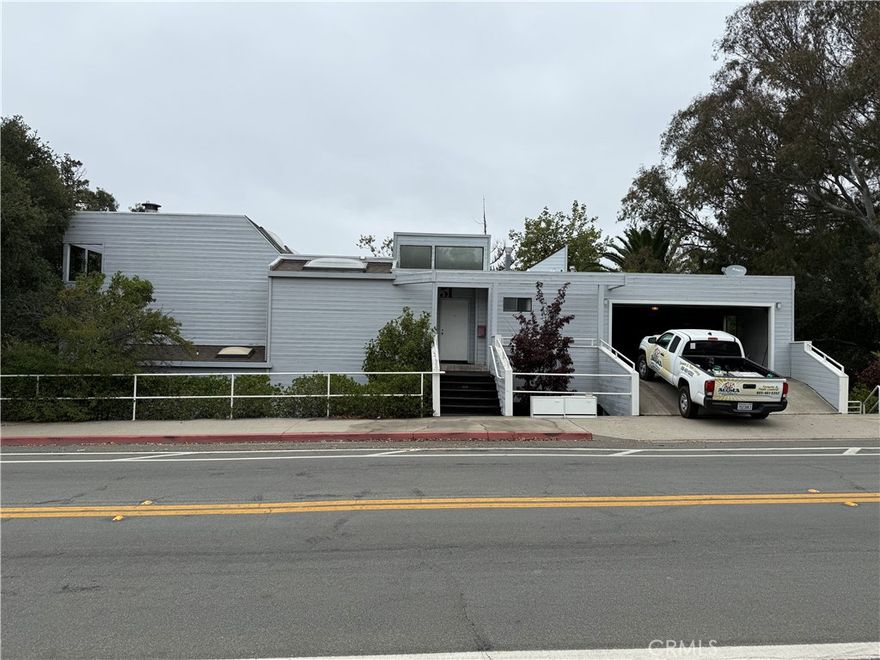 This is a rare opportunity to own a piece of Cal poly history. This house was designed and built in 1988 by Alice and Larry Loh, who were both tenure Cal Poly instructors since the 70's in Landscape Architecture and Architecture, respectively. This beautiful home is extremely unique, with it's architecture and location. It's post modern design offers clean lines and generous amounts of light to flood the interior spaces. Also, it's adjacent proximity to Cal Poly campus makes it one of the closest residences sharing a property line with the campus. Just a few steps from the Recreation Center. The large downstairs bonus room is designed with a kitchenette and full bathroom. It is set up to be divided into a two bedroom apartment with its own entrance on the side. This modification would create a two spacious bedroom apartment in addition to a three bedroom three bath house. Local codes and conformity to be determined by buyers. From the upstairs deck there are views of both Madonna mountain and Bishop's Peak. There is also, a creek that flows through the backyard. The owner/architect/builder designed the structure to be able to build an additional 1200 square-foot structure below the existing structure in the future. Plans have not been drawn for this ADU.