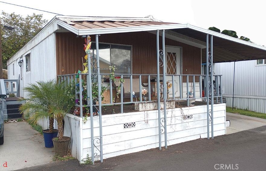 Roof is about five years old. home was leveled about five years ago. Floors were replaced with composite type tongue and groove. Has a 3 year old Goodman heat pump / air conditioner. Very efficient. Copper plumbing **Presenting this charming 2-bedroom 2-bathroom home just 15 min from the Beach! Gated Serene 55+ with clubhouse and pool / Jacuzzi in community! modern kitchen , stainless steel appliances. , spacious living room. 1 carport parking, has a yard. Equestrian trail along the LA river in the back. "yard". Near a soccer and fitness park. Close to the 405 and the 710 for easy commuting. Price is right to be close to the beach!  *Low Lot Fees : 980 +utilities