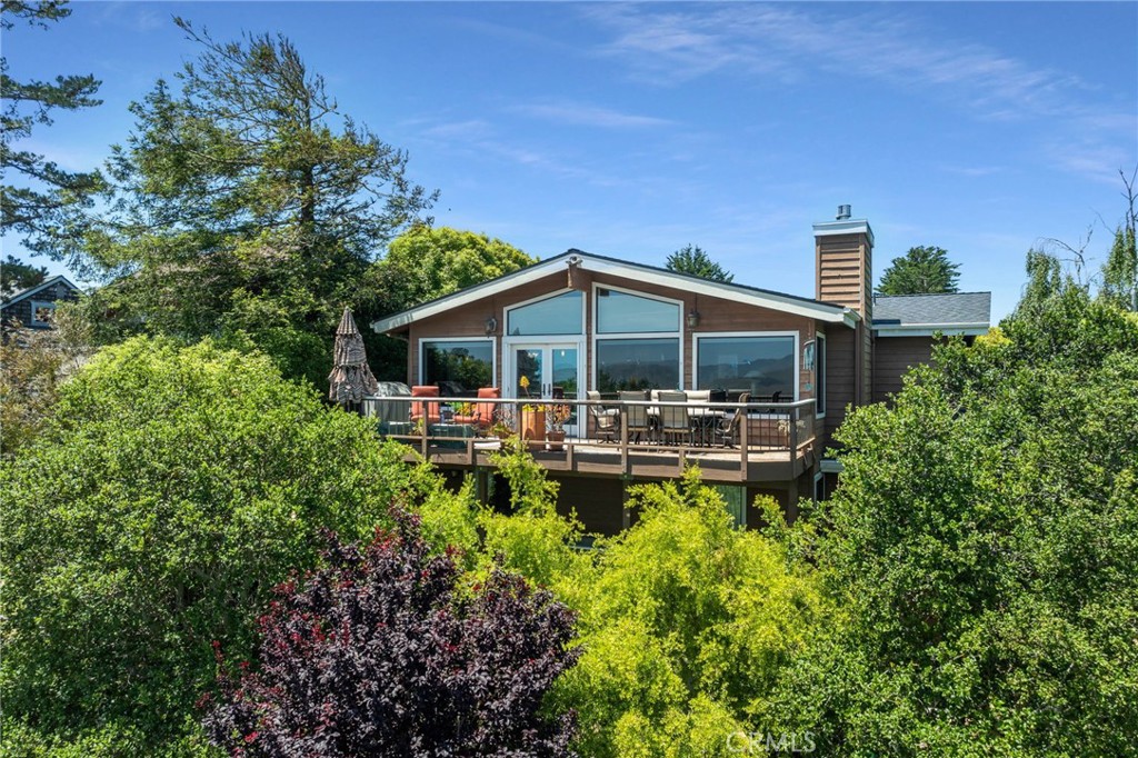 Top of the World – Exceptional Cambria Retreat with Panoramic Views
Perched in Cambria’s coveted “Top of the World” neighborhood—known for its highest elevation and abundant sunlight—this stunning bi-level home offers unmatched vistas and a rare combination of privacy, warmth, and modern upgrades.
Enjoy breathtaking 180-degree views of the Santa Lucia Mountains to the east, and a peek of the Pacific Ocean to the west. Built in 1987 by respected local contractor Paul Dustin, this home was crafted with cutting-edge earthquake-resistant techniques of its time.
Step inside to discover vaulted ceilings lined with cedar planks, complemented by rich Virginia Vintage 5" hardwood maple flooring and 11 new alder wood interior doors, casings, and 5-inch baseboards. The living area centers around a new gas-burning fireplace insert, framed by custom walnut built-in cabinetry and mantle, and a gorgeous slab of quartzite—perfect for cozy Cambria evenings.
Modern amenities include:
10 premium LG solar panels on a brand-new roof
8 new Pella fiberglass windows
Newer 50-gallon gas water heater
Natural gas furnace with added UV filtration & air purification
The expansive 8997 sq ft lot spans four oversized street-to-street parcels, offering beautifully landscaped grounds with stone-raised garden beds, fruit trees, and multiple patio areas to soak in the serene views. A built-in natural gas firepit with stone bench seating sets the tone for outdoor entertaining.
Accessibility is a breeze thanks to new concrete stairs from the lower street level. Two newly constructed 10x12 multi-purpose units each feature their own fenced outdoor play areas—perfect for guests, workspaces, or hobbies. Additionally, a secondary rainwater catchment system provides 1,850 gallons of sustainable water storage.
As a licensed vacation rental, this property is not only a personal sanctuary but a profitable investment opportunity.
Truly a rare gem—you must see it to believe it!