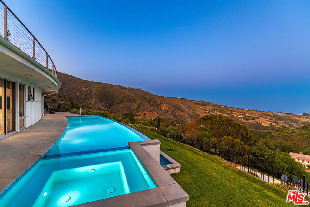Discover an extraordinary architectural estate with pool and ocean views in Malibu, masterfully completed in 2019. This stunning 5-bedroom, 5.5-bathroom main residence offers 4,400 sq.ft. of luxurious living space, complemented by a permitted detached guest house boasting an additional 1,200 sq.ft. with 3 bedrooms and 2.5 bathrooms, perfect for hosting family and friends or as an inspiring workspace. Perched to capture breathtaking ocean and hillside views stretching from the Queen's Necklace along Santa Monica Bay to the distant Channel Islands, this home's design and craftsmanship are unmatched. Viking appliances, custom-made cabinetry, quartz countertops, ceramic tiles imported from Spain, and Canadian maple hardwood floors define the sleek and modern interior. German Duravit toilets and seamless finishes further elevate the home's refined style. This property is fully solar-powered, featuring back-up Tesla batteries to ensure uninterrupted power and wifi connectivity, a must in Malibu's dynamic coastal climate. Entertain in style on the expansive 1,300 sq.ft. ocean view deck with an outdoor kitchen BBQ, or unwind by the natural gas-heated infinity pool and spa, complete with a surrounding sundeck and lush lawned backyard. Families will delight in the dedicated children's play area. Ample on-site parking and a 2-car garage with built-in storage ensure convenience for all. Ideally located with easy access to Paradise Cove Beach, Point Dume Market, and shops, and nearby top-rated schools, this architectural gem blends privacy, luxury, and functionality in one of Malibu's most coveted locations. Can be leased unfurnished for $24k per mo. Also available for SALE at $6,250,000.