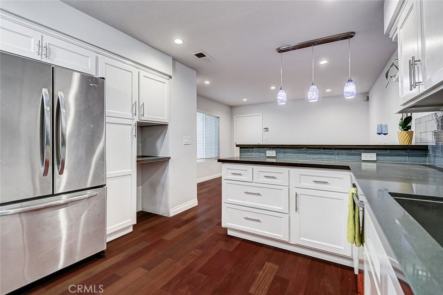 Turnkey remodeled 3-bedroom, 2.5-bath townhome in a desirable gated Gardena community. The home features a bright, welcoming layout with a spacious living and family area downstairs, complete with beautiful flooring and a cozy gas fireplace. A skylight over the stairs fills the space with natural light, and high vaulted ceilings upstairs create an open, airy feel. Large sliding doors open to a private backyard, perfect for relaxing, entertaining, or picking lemons from your own tree. The interior location ensures peace and quiet, away from street noise.



The remodeled kitchen boasts modern white cabinetry, quartz countertops, and stainless-steel appliances, including a dishwasher. A convenient half bath is located on the main level, along with direct access to the attached two-car garage, which features built-in storage cabinets.



All bedrooms are located upstairs, with the laundry area nearby for convenience. The primary suite offers two walk-in closets with custom shelving and a beautifully remodeled bathroom with dual sinks, a tub/shower combo, and a separate vanity area. All bathrooms have been tastefully updated.



Additional highlights include air conditioning for hot days, an upgraded electrical panel, and a gated community with a sparkling pool. Nothing to do but move in!