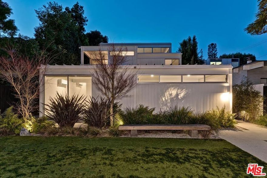 The personal residence and architecture studio of renowned architect Pierre Koenig, FAIA, exemplifies his iconic status in Mid-Century Modernism. Often hailed as the "Rock Star" of this architectural movement, Koenig designed legendary homes such as the Stahl House (Case Study House #22) and the Bailey House (Case Study House #21) two of the most documented modern residences of their time. Historically archived as "Koenig House #2" by the L.A. Conservancy, this steel-and-glass masterpiece offers exceptional privacy with tiered setbacks and hedges leading to a striking 30-foot, three-story vertical atrium. This dramatic space, intersected by landings and staircases, is bathed in natural light from full-height clerestory windows. Meticulously restored in 2024 (see docs) and the upstairs bathrooms, kitchen and pool in 2020, the home features three bedrooms, two and a half bathrooms, a parlor, and a media/family room connected to Koenig's architecture studio, which opens to a magnificent courtyard. True to Koenig's signature open floor plan, the I-beam steel frame defines the living spaces both vertically and horizontally, seamlessly integrating structure and design.This residence stands as a definitive expression of Koenig's architectural vision, embodying the essence of modernist living. The home is extraordinarily private and serene, yet central to everything Brentwood has to offer; the schools, shopping, restaurants, and weekly Farmer's Market, and is set back on a beautiful tree-lined street. Can be purchased fully furnished.