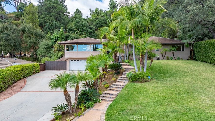 Located in the prestigious Highland Oaks area of Arcadia, 2047 Carolwood Drive is a beautifully single-family home offering elegant living space on a 0.43-acre lot. Featuring 4 bedrooms and 3.5 bathrooms, this residence combines luxury and comfort with its open, functional layout. A grand double-door entry welcomes you into a bright formal living room with large picture windows showcasing mountain views, while the formal dining area provides an ideal setting for gatherings. The gourmet kitchen is equipped with Thermador stainless steel appliances, granite countertops, custom cabinetry, and a center island. The master bedroom has its own bathroom. Additional suite offering its own private bath. Outside, the landscaped backyard features a covered patio, rose garden, fruit trees, and tiered lawns—perfect for entertaining or quiet relaxation. The home sits within the highly rated Arcadia Unified School District, serving Highland Oaks Elementary, Foothills Middle, and Arcadia High School, making it an exceptional opportunity for those seeking refined living in one of Arcadia’s most desirable neighborhoods.