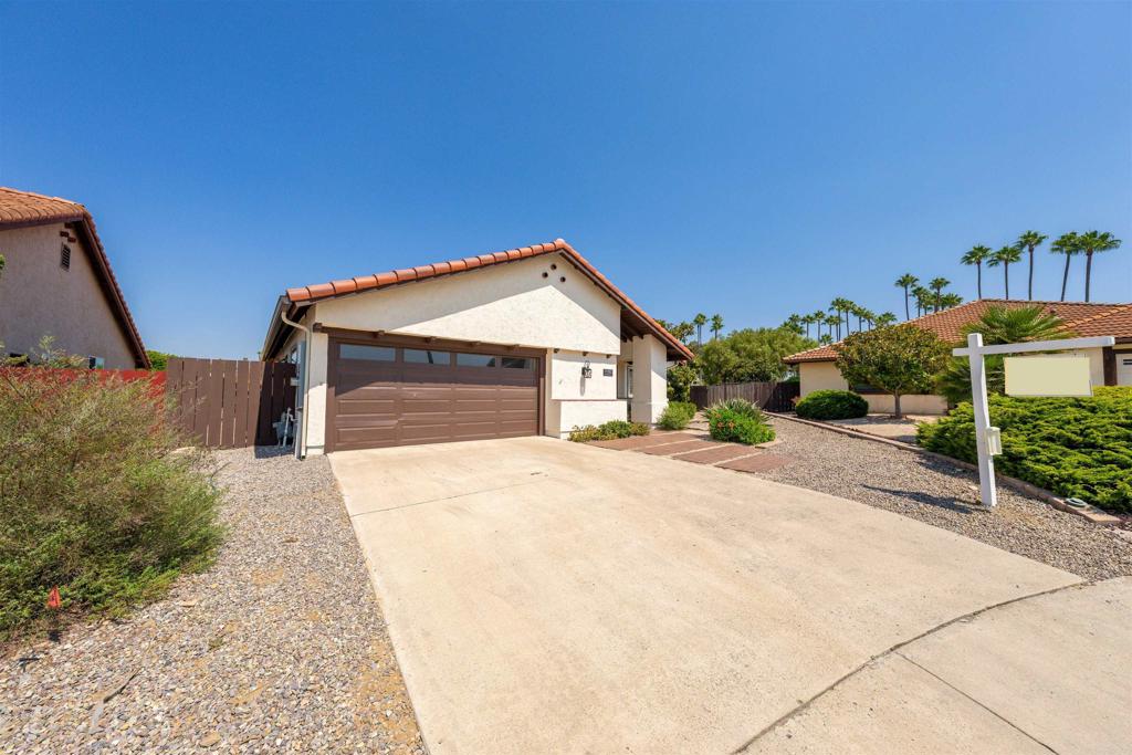 Resort-Style Living in a 55+ Community – Remodeled & Move-In Ready! Step into luxury and comfort in this recently remodeled & upgraded 3-bedroom, 2-bath home designed for easy living and elegant entertaining. Every detail has been thoughtfully updated—from the custom double glass entry doors generating a stunning first impression to the designer tile wood-look flooring to beautifully renewed baths — creating a fresh, modern feel throughout. Inside, enjoy a spacious living room with fireplace, a separate and welcoming family room with another fireplace & a convenient wine frig both featuring high ceilings enhancing the open, airy atmosphere. The gourmet kitchen new cabinets with spacious quartz countertops, all new double oven, smooth-top range, dishwasher, refrigerator enhanced with a bay window and recessed lighting adjacent to the formal dining room with Plantation Shutters framing the back patio, pool & spa. The Primary Suite is a retreat of its own, offering double closets, mirrored doors, and a spa-like bath with dual sinks & a separate water closet. Ceiling fans throughout keep everyone comfort in every room. The 2-car attached garage is finished with a gleaming floor, powered opener, a work area and extra storage. In back, step outside through one of three sliding glass doors to your private backyard oasis: a covered patio, lap pool with automated cover, spa, and a sunny side patio. EVEN A separate fenced garden & orchard boasts producing avocado, apple, lemon, orange, and grapefruit trees and raised garden bed—perfect for homegrown delights. The lot is beautifully landscaped for low maintenance assuring you more time to enjoy all that is here. This is more than a home—it’s a lifestyle placed on a cul-de-sac corner of a welcoming 55+ community.