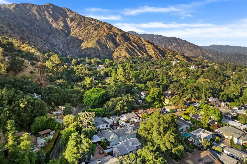 Tucked away, in a historic town called Sierra Madre. At the foothills of the San Gabriel Valley and below the southern edge of the Angeles National Forest. Surrounded by lush green trees and beautiful wild flowers, the wind whistles through. Crisp air and occasional wild life make for a peaceful setting no matter the time of day. This timeless Victorian masterpiece, is now open for new memories to call your own. Newly built in 1989, with the great outdoors in mind, windows were placed throughout the home to welcome the nature that surrounds. Backed to a Private Road is a 2 car garage. A third option carport is on the North-West side of the property. Morning coffee or afternoon tea favorite spots are out front on the porch bench or in the covered sun room open breezeway. Meticulously maintained and well-loved. Upon entering is a cozy living space. An open floorplan makes for a spacious feel. The expansive master suite is located on the main floor. A gorgeous wooden staircase provides optional separate living with 2 additional bedrooms, a full bath, and a sitting room. French doors lead to a near wrap around patio currently enjoyed as an outdoor lounge area. Additionally, an estimated 300 square foot attic space (not included in advertised square footage) with high ceilings has been converted into a fully functionally living space. Feel like taking a walk or hike? This is the place to do it! Explore local beautiful sites, curbless roads, churches, and Downtown shopping and dining. With the city life close by, you will find this location, the perfect getaway, to call home.