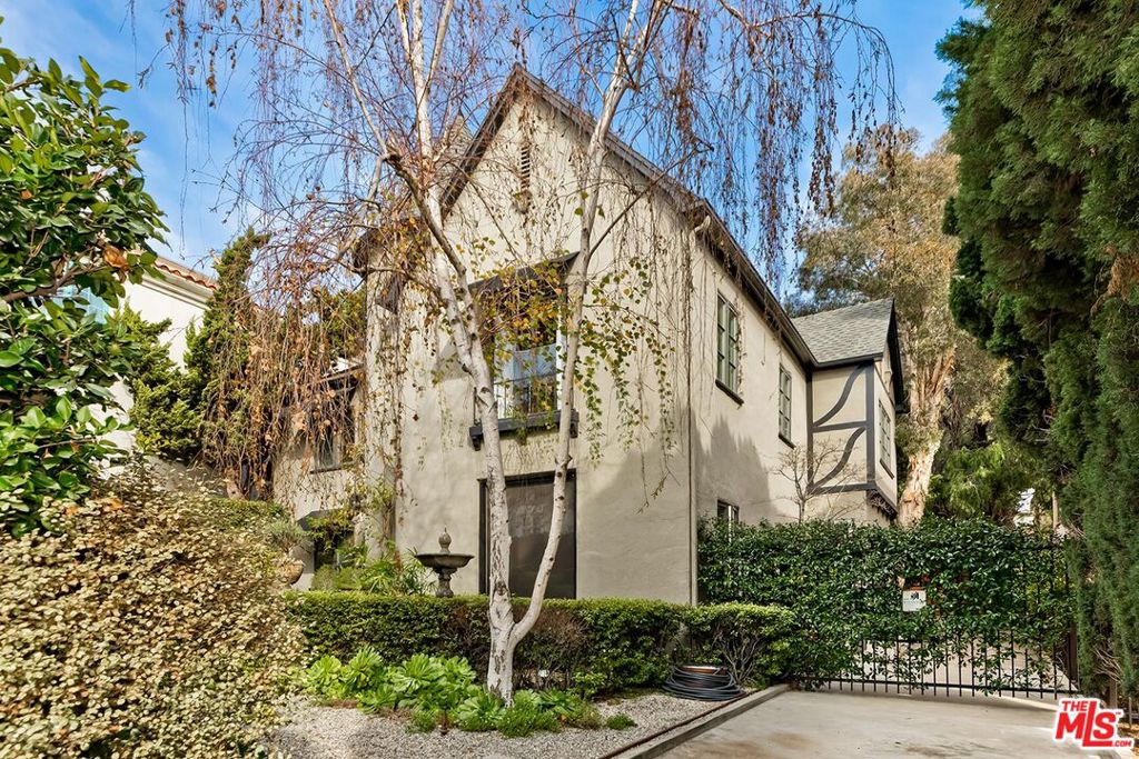 Experience the perfect blend of vintage charm and modern convenience in this beautifully renovated upper unit. Nestled within a 1926 French Normandy duplex, this generous 2-bedroom, 1.5-bath gem is an exceptionally rare find. The property's private, gated grounds and mature landscaping offer a sense of seclusion and serenity, that will transport you to a French Oasis, creating a truly unique living experience. Perfect for those who love to host, this home is designed for seamless entertaining. The generously sized living room, with its dramatic barreled ceiling and decorative fireplace, flows into a distinct dining area, all bathed in natural light from the expansive windows found throughout the residence. The gourmet kitchen, meticulously updated, boasts a large window overlooking the verdant landscaping, private balcony perfect for al fresco dining, and direct access via a staircase to the yard. Both bedrooms are light and bright accented with crown moldings, large windows, and recessed lighting. Bathrooms are flushed with natural lighting and updated to perfection.