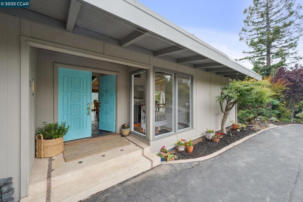 Perched in the rolling hills of Orinda in the highly regarded Del Rey neighborhood, this stunning 4-bedroom, 3-bath Mid-Century Modern home captures the essence of California living with breathtaking views, clean architectural lines, and a seamless connection to nature. Enter an open-concept layout flooded with natural light, floor-to-ceiling windows, vaulted wood-beam ceilings, and polished stone floors. The living and dining areas open onto a covered deck, offering a front-row seat to Orinda’s serene hillsides and glowing sunsets. The kitchen comes with stone countertops, extensive cabinetry and stainless steel appliances. The primary suite has an ensuite bath and access to the deck. Three additional bedrooms offer flexibility for guests, or home office needs. The lower level has a second living area with a 3rd bath. The home includes multiple outdoor living areas ideal for dining, lounging, or stargazing. More features include mature, drought-tolerant landscaping, owned solar with a carport for two with a Tesla charger and Tesla Power Wall. Top-rated Orinda schools and just minutes to BART, hiking trails, and downtown. A rare opportunity to own a timeless architectural gem with unmatched views and privacy — come experience the beauty of Orinda in classic mid-century style. Views: Ridge
