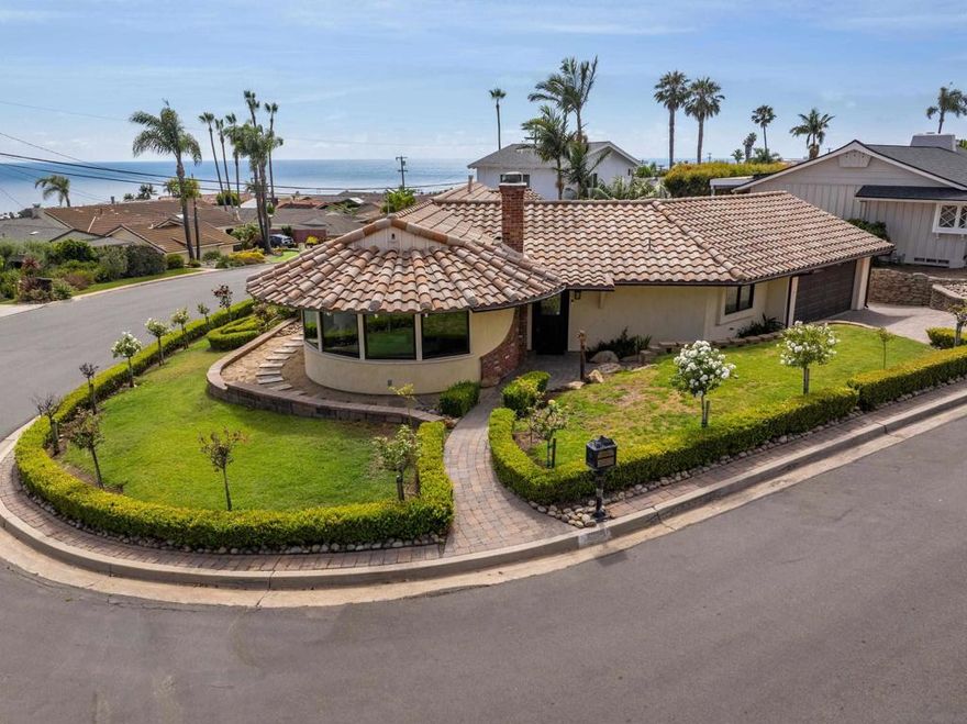 Delightful single-level home with dazzling ocean, coastline, and city light views in the serene La Jolla Mesa neighborhood, nicely situated on the sunny side of Mount Soledad! Nestled on a corner lot, this home enjoys abundant natural light, refreshing ocean breezes, and ocean views from most areas of the property. Inside, an open-concept kitchen with elegant quartz countertops flows seamlessly into a gorgeous living room featuring a classic brick fireplace, custom Marvin windows with up/down shades, and beautiful hardwood floors throughout. With 3 spacious bedrooms, 2 full bathrooms, central AC, and an attached 2-car garage, this home offers an effortless, comfortable floor plan. Outside, the well-manicured grounds include a stylish private paver courtyard and driveway, providing an inviting outdoor space for relaxing or entertaining. A true joy in a fantastic location, this property is convenient to everything La Jolla and nearby Pacific Beach have to offer!