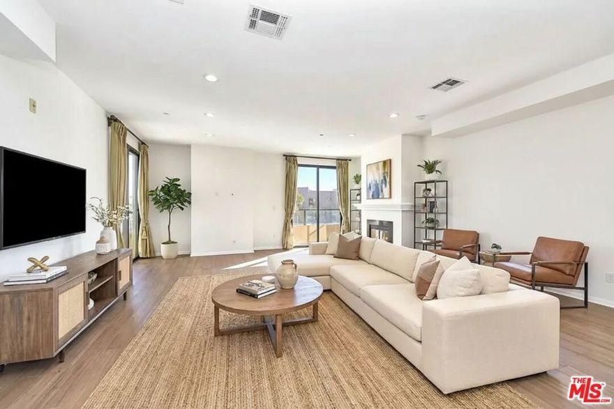 A fresh new look with a new price! Tucked away in one of Los Angeles' most timeless neighborhoods, this rare 3-bedroom, 2-bath residence in Hancock Park is one of the largest units in the building, offering 1,630 sq of elegantly upgraded living space, plus a private extra storage area for added convenience. Unlike most units in the complex that remain in their original condition, this home was fully remodeled from floor to ceiling just a few years ago, featuring new flooring, fresh paint, LED recessed lighting throughout, and modern chandeliers. The spacious master suite, thoughtfully separated from the guest bedrooms for privacy, features a walk-in closet and a luxurious bathroom with a large soaking tub, separate shower, dual sinks, and private patio access. The chef's kitchen boasts granite countertops, custom cabinetry, stainless steel appliances, and a large pantry-a rare feature in this building. The open floor plan is framed by floor-to-ceiling, double soundproof UV-coated windows that fill the home with natural light while offering breathtaking city light and fireworks views from every room. Step out onto the wraparound balconies, accessible from all rooms, and take in the vibrant skyline. Conveniently located at the epicenter of both the Metro Purple Line and Crenshaw/LAX stations, offering direct access to LAX, Santa Monica, and Downtown LA, this residence captures the essence of urban sophistication and modern convenience. This is more than a home; it's a statement of timeless design and contemporary living-right in the heart of Hancock Park.