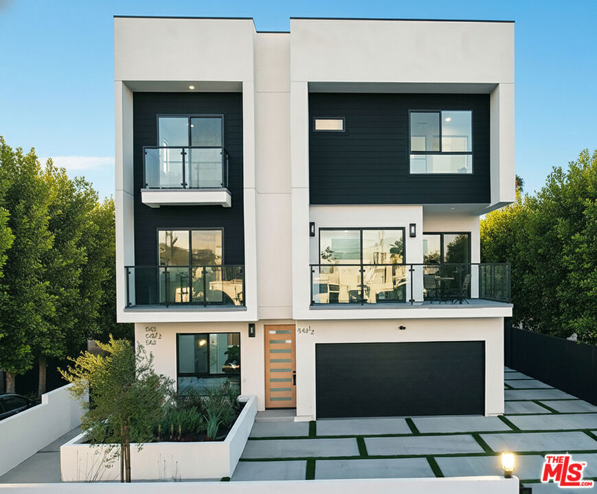 Perfectly positioned between the creative pulse of Hollywood, the charm of Larchmont Village, the historic character of Melrose Hill, and the vibrant energy of Koreatown, this home offers a rare blend of cultural access and neighborhood distinction. Unveiling a sophisticated urban living, this brand-new 2025 built home offers an unrivaled blend of elegant design and expansive spaces that culminate in an opulent lifestyle experience. Step inside to discover an interior where every detail has been thoughtfully curated for discerning tastes. The residence boasts soaring 10-foot ceilings, stylish shaker-style interior doors, and an abundance of natural light pouring in through oversized sliding glass doors that open to multiple serene balconies. The thoughtfully designed interiors offer a harmonious blend of space, light, and comfort, unfolding with an open-concept layout that highlights exquisite high-end finishes and premium materials throughout. From the wide-plank floors that unify the interiors to the fixtures, each element contributes to an ambiance of refined elegance and unparalleled comfort. At the heart of the home lies a chef's kitchen, an absolute dream featuring a central panel-wrapped island, warm wood custom cabinetry, and premium stainless-steel appliances an ideal space for both daily life and sophisticated entertaining. With ample storage and a conveniently located washer and dryer, this home ensures comfortable living for you and your family in its 4 spacious bedrooms and 4 elegant bathrooms. Additionally, enjoy the convenience of a direct access side-by-side 2-car garage plus 2 uncovered parking spaces. The crown jewel is an expansive 779 square feet private rooftop terrace, your personal sanctuary that commands breathtaking, uninterrupted panoramic views of iconic landmarks like the Hollywood Sign, Griffith Park Observatory, and the dazzling Downtown Los Angeles skyline. This magnificent outdoor haven is a true entertainer's paradise, purpose-built for entertainment and offering 360-degree vistas. It features a fully-equipped outdoor kitchen complete with a natural gas BBQ, an integrated fridge, a convenient sink, and a pizza oven. Composite decking, artificial turf and charming string lighting complete this exquisite space, perfect for hosting unforgettable gatherings or simply unwinding under the stars. Centrally located near major employers like Paramount Studios, Netflix, Kaiser Permanente, Children's Hospital Los Angeles, and Los Angeles City College, this home also offers seamless access to key transportation corridors including the 101 Freeway, Beverly Blvd., and Melrose Ave., connecting you to Downtown and beyond with ease. Schedule your private tour today.