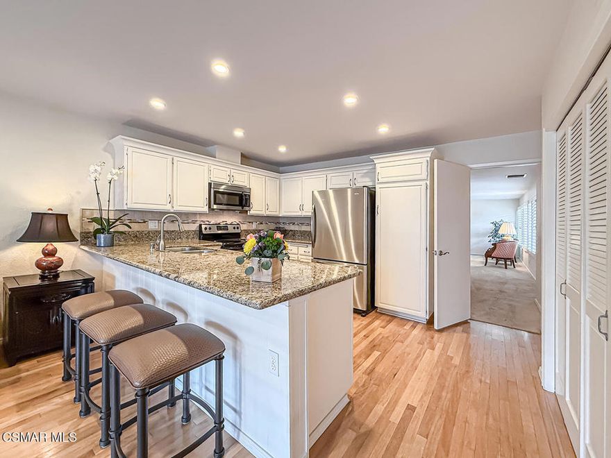 Charming Single-Story Retreat in the Heart of Westlake Village with NO Interior Steps, NO Rear Neighbor, CORNER Location, PRIVATE Front & Back Patios, UPGRADED Kitchen & Baths, and WALKABILITY to Westlake Lake! Tucked within the peaceful and well-maintained community of Triunfo West, this 2-bed / 2-bath home offers a bright floorplan with community features including TWO Pool & Spa areas! From the moment you enter the gated front patio--lined with lush greenery--you'll appreciate the sense of calm and comfort that defines this property. Step inside and you're welcomed by HANDSOME real wood flooring and an open-concept Living & Dining Room with plush carpet, a dual-sided fireplace, and THREE pairs of tall windows that overlook the patio, bathing the space in natural light. The upgraded Kitchen boasts attractive granite countertops, mosaic-tile backsplashes, a stainless-steel sink, and matching Frigidaire stainless-steel appliances--all complemented by ample cabinetry & pantry storage! A bright and inviting Family Room sits just off the Kitchen, enjoying large sliding glass doors that open to the backyard and frame serene green views. Tucked behind bifold doors, the indoor Laundry Area flanks the Kitchen to make laundry effortless & convenient! The spacious Primary Bedroom is a peaceful sanctuary with tall windows & sliding glass doors to the backyard, and TWO mirrored closets. Its en-suite bathroom features an upgraded stone-topped vanity with skylight above, plus a separate water room with fully revamped shower, artistic tilework, and frameless glass doors. The Secondary Bedroom offers excellent flexibility--perfect for guests or a home office--with wood flooring, a FANTASTIC Murphy bed, built-ins, and views of the front patio. The full Hall Bathroom has also been redone with upgraded tile floors, a built-in stone-surfaced vanity, and a redone tub/shower combo with tile surrounds + frameless glass doors! Step outside to your PRIVATE backyard retreat--with NO rear neighbor--only peace and greenery beyond! Enjoy the covered concrete patio and side pathway which showcases a VIBRANT row of blooming rose bushes in every shade--pink, red, yellow, orange, white and more! Your 2-car garage is directly accessible from the front patio and is complete with built-in cabinetry. Residents of this sought-after community enjoy access to TWO sparkling pools & spas, shuffleboard courts, greenbelts, and scenic walking paths--all just moments from Westlake Lake, boutique shopping, and fantastic restaurants.This is the kind of peaceful, bright, and thoughtfully updated home that rarely comes available in such a prime Westlake Village location--don't miss it!