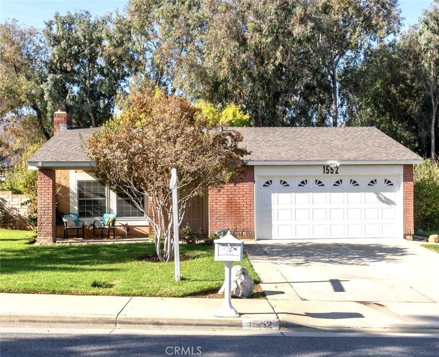 Welcome to this Charming Corona Home – Minutes from Orange County!
Step inside to a warm and inviting family room featuring a cozy fireplace and a lovely neighborhood view. The open kitchen flows seamlessly into the dining area, complete with a large sliding door that opens to the backyard—perfect for indoor-outdoor living and entertaining.
All bedrooms are a good size, and the primary suite includes its own private bathroom. The backyard offers a spacious covered patio made of Vinyl composite which is durable and low-maintenance.   Includes a storage shed positioned at the back of the property.
Additional highlights include double-pane tilt-in windows—allowing you to easily clean the exterior glass from inside—central air and heat, newer vinyl flooring throughout, and a newer roof.