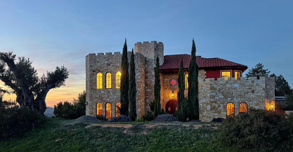 Luxury inside-outside living on a top of the hill! Beautiful custom home, castle inspired, on 2 acres of well-maintained grounds in 10-minute drive from downtown Saratoga. One of the most scenic roads in California, with views getting better when getting higher. Tennis court, mature Vineyard and vegetable garden; built-in grill; pizza-oven; water well-"free water". Magic of ancient olive trees and the Bay Laurel tree forest, mature Kwanzan Sakura and Red Dragon Japanese maple. Two story 2007 built 4 bdr 2.5 bath 2918 sq ft house with attached oversized 2 car garage features hardwood floors all around and artistic details. On the ground floor there are chefs kitchen, spacious dining room with adjacent wine room; office/bedroom, living room with a wood burning fireplace and exits to the backyard; a 1/2 bathroom. Elegant stairway leads to the second floor. There are the large family room/library; a master suite, two additional bedrooms; full bathroom and a laundry room. Relax in a hot tub on a roof top terrace. Plenty of parking space in the driveway. Enjoy views of the hills and canyons, of San Francisco and Monterey Bay Peninsula, the hiking trails of El Sereno Open Space Preserve and Sanborn Park. Excellent Saratoga schools. Must see in person to truly appreciate the beauty!