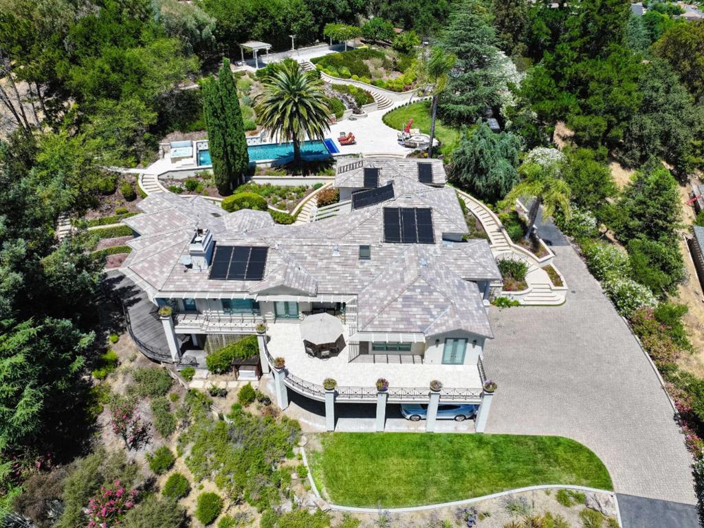 Stunning estate with extraordinary views from every room. Heavenly ambiance with a private setting feels remote while being close to amenities. Exquisite architectural details, secure gated entry, high ceilings, Travertine and Porcelain tile floors, and artistic glass accents. Chef's kitchen with 2 dishwashers, 3 en-suites with walk-in closets, office with built-in desk and bookshelves, billiard game room with wet bar and attached bathroom with wet sauna and Toto bidet. Gym with built-in mirrors and ballet bar with an attached bathroom, wine cellar, and 2 car garage with an additional carport. Movie theater media-room with decorative, adjustable LED lighting, and 8 reclining seats with footrests. Expansive yard with gorgeous pool, elegant waterfalls, multi-purpose sports court for Pickleball, Basketball, or Volleyball, Bocce Ball court with pergola, and incredible landscaping. Desirable schools: Foothill Elementary, Redwood Middle, and Saratoga High. Near Tech companies, Downtown Saratoga, Wildwood Park, Saratoga Quarry Park, and Argonaut Shopping Center.