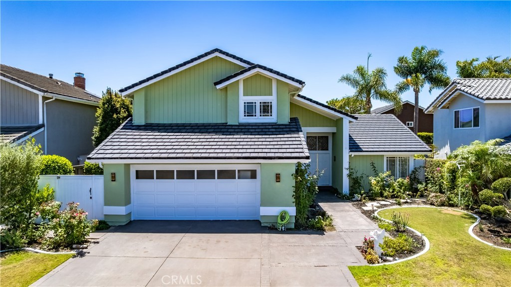 Beautiful 4-bedroom, 2.5-bath home in the sought-after Landing community with over 2,300 square feet of living space. Just minutes to Bolsa Chica Wetlands and the beach, this home features a bright living room with vaulted ceilings and French doors that open to a landscaped backyard with a spa. The upgraded kitchen includes granite counters, stainless steel appliances, custom cabinets, and a wine fridge. A cozy family room with a fireplace and built-ins also opens to the backyard. The main floor includes a convenient downstairs bedroom, half bath, laundry room, and direct garage access. Upstairs offers new carpet, fresh paint, and three spacious bedrooms. The primary suite has dual closets, a skylit soaking tub, and a window seat overlooking the yard. Enjoy a private backyard retreat with a covered patio and spa, all within walking distance to parks, shops, dining, and the beach.