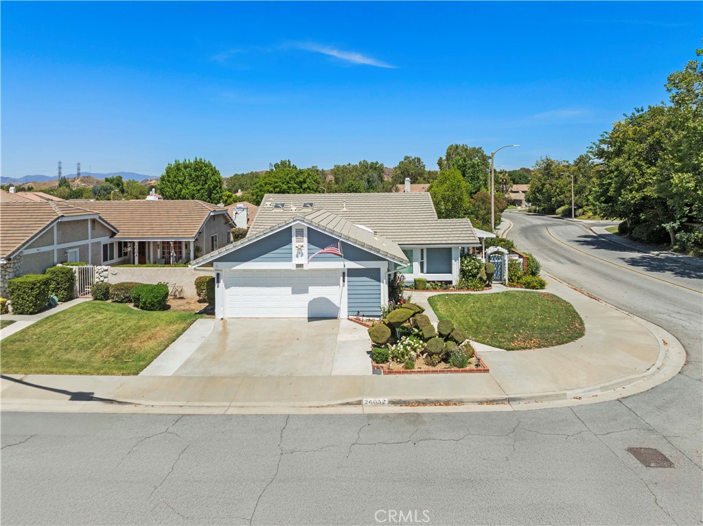 Adorable single-story home situated on a large corner lot with low HOA fees and no Mello-Roos taxes. Enjoy great curb appeal and a bright, open floorplan filled with natural light. As you enter, you'll find a dining area that flows seamlessly into the spacious living room featuring a charming brick fireplace and abundant windows. The large eat-in kitchen is beautifully appointed with a custom backsplash, stainless steel appliances, built-in TV and quartz countertops. The generous primary suite includes a built-in audio system and slider leading to the yard. Step outside to a lovely yard with two covered patios, whole yard surround system, a grassy area, and a fully insulated workshop—perfect for entertaining or relaxing. HOA amenities include access to three pools and parks. Conveniently located near the hospital, shopping centers, Westfield Mall, the 5 freeway, and more.