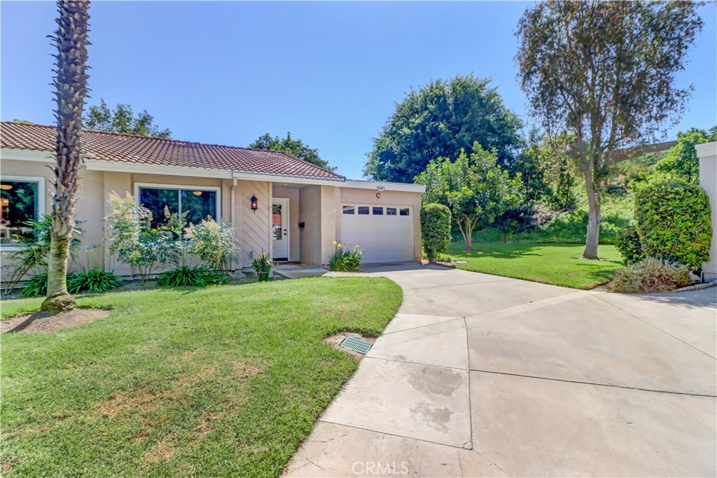 Enjoy the peace and serenity of Laguna Canyon! 2BD/2BA "Las Flores" end unit condo with 1 car attached garage. You'll love this great location with a huge greenbelt off to the side - perfect for pets and grandkids - and adjacent to Laguna Canyon Nature Preserve. Easy access street with guest parking and driveway. Excellent curb appeal walking up with grass and slopes all around. Upgraded front door has large leaded glass insert to let a bit of light in without sacrificing privacy and leads to the spacious living room with large window facing southwest for afternoon sun. Notice the smooth ceilings, dual pane windows and central HVAC. Dining area is brightened by recessed lights plus ceiling fan and has access out to the enclosed sunroom area. This added room is approx 250 sq ft of usable living space with added storage and exterior access door. Back inside, the remodeled kitchen boasts updated soft cream cabinetry, granite countertops, breakfast bar, newer white appliances and recessed lights with a window over the kitchen sink looking out to the sunroom. Down the hallway, guest bath is remodeled with tub, tile surround and glass enclosure. Upgraded vanity and fixtures complete the space. Both bedrooms are in the front of the home and have their own ceiling fans for air circulation. The primary suite enjoys a beautiful bathroom with Solartube, dual sink vanity and tiled walk-in shower with seat and glass enclosure. Both bathroom floors are tiled. Attached one car oversized garage houses the washer/dryer and water heater with direct access to the interior. This is an amazing home in one of Laguna Wood's premium areas! Laguna Woods Village residents enjoy a 27-hole championship golf course, a 9-hole executive par 3 course, pickleball and tennis courts, lawn bowling, gyms, clubhouses, swimming pools, horse stables, gardening centers, artist studios, computer workrooms and classes + over 200 clubs and organizations. CHECK OUT THE VIRTUAL WALK-THRU TOUR. CLICK THE WHITE CIRCLES TO WALK THROUGH, 360 ICON TO WALK OUTSIDE TO SEE THE VIEW AND WALKING PERSON ICON TO COME BACK INSIDE. ENJOY!