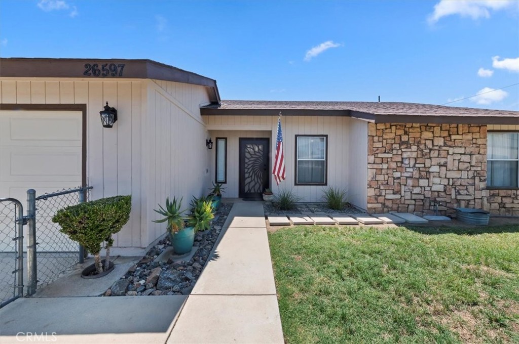 Welcome to 26597 Columbia Street, a Gorgeous turn-key home! Beaming with pride of ownership, this loving home has been in the same family since it was new! This home has been upgraded with 18” Italian ceramic tile flooring throughout the living room, dining room, kitchen, grand-entrance, bathrooms, and the hallways. The generously sized kitchen includes ample cabinets and counter space, barstool seating, stainless-steel appliances, and beautiful natural wood cabinets! The kitchen opens to the formal dining room which features French doors that open to the beautiful backyard providing an abundance of natural light. The living room, with its stunning flagstone fireplace, is just perfect for all of your family gatherings and fellowship. The spacious primary bedroom suite includes real hardwood flooring, new baseboards, French doors that open to the backyard patio, an ensuite bathroom with two designer sinks and a walk-in low-threshold shower! Just down the hallway from the guest bathroom are the two guest bedrooms. Both guest bedrooms have been freshly painted, have new baseboards, and are uniquely designed, one with Bamboo designer flooring and the other with new “Lux” vinyl flooring! In addition to all of this home’s outstanding features and upgrades, it also includes a freshly painting grand entrance foyer and a two-car attached garage that has a newer roll-up garage door! And outdoors, you’ll find everything you need...an absolutely beautiful “Shangri-la” backyard with gorgeous shade trees, an aluma-wood-style and regular-wood style full-length covered patio. This home also has an extra-large side yard that includes a fully fenced dog run, a fruit and vegetable garden with a variety of producing citrus trees, a mature grapevine, and several different types of vegetables. (This space can also be used for RV parking if you’d prefer!) And last, but not least, this property is fully fenced with chain-link fencing, including a newer front sliding gate! Centrally located too, it’s just minutes from schools, the Western Science Center, Diamond Valley Lake, the Page Plaza shopping center, and great restaurants. And for more great entertainment, the Soboba Casino Resort is also just a short drive away! This must-see turn-key home is just waiting for you to move in! Don’t delay…Call Today!