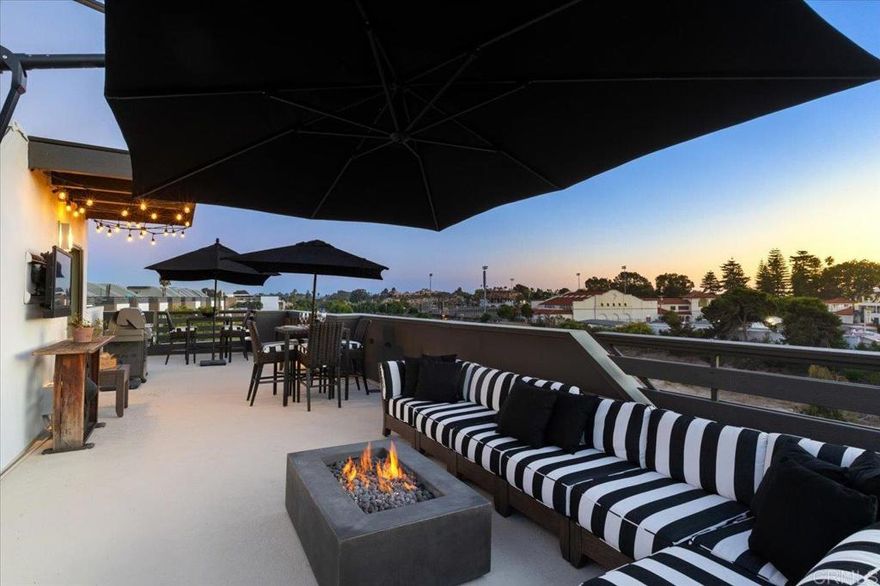 Live the Luxury Coastal Lifestyle in the Heart of Carlsbad Village! Welcome to your dream retreat on State Street, where modern sophistication meets laid-back coastal charm. With over 2,100 square feet of beautifully designed interior space and an expansive, private rooftop deck, this swanky coastal condo places you within steps of the lagoon, beach, boutique shops, and the vibrant dining scenes of both downtown Carlsbad and South Oceanside. Natural light floods every level of this three-story end unit, highlighting custom finishes, rich wood floors, high ceilings, and an effortless flow throughout. Enter through the private courtyard or your oversized two-car garage into a versatile first-floor flex space -perfect for a living area, guest suite, or home office. The second floor showcases the heart of the home with a stunning chef’s kitchen featuring a large island with leathered granite countertops, custom cabinetry, designer fixtures, and top-of-the-line stainless steel appliances. The open-concept dining and living areas are ideal for entertaining or relaxing, complemented by two balconies- one for morning coffee or evening BBQs and another charming French balcony right off the dining room. Upstairs, the third-floor hosts both bedrooms and laundry. The guest suite includes an ensuite bath, a walk-in closet, and its own French balcony. The primary suite is a serene sanctuary with west-facing windows framed by eucalyptus trees, a spacious walk-in closet plus two additional closets, and a spa-inspired bath with dual vanities and a spacious shower. Saving the best for the last…the final and fourth floor takes you to your private rooftop deck - the ultimate outdoor escape- offering panoramic ocean and city views, refreshing sea breezes, and unforgettable sunsets over the Village. Whether enjoying morning coffee, sunset dinners, or starlit gatherings, this is the space that will make you fall in love with coastal living for the first time or all over again. Additional features include dual A/C units, a whole-house water filtration system, EV charger, ample storage, custom window blinds, and ceiling fans throughout. Seagrove is just steps from the best that Carlsbad Village and South O have to offer -world-class dining, local boutiques, beaches, train station and coastal trails -this home blends luxury, convenience, and the irresistible energy of seaside living. Your coastal dream home awaits.