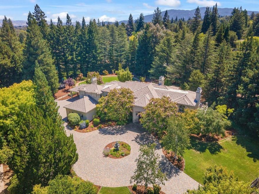 Saratoga's prestigious Platinum Triangle! Serene estate offers luxurious living! 1.3 acres of enclosed, level manicured grounds, close to top-rated schools, scenic trails, & dwntwn Saratoga Village. Majestic redwoods surround perimeter for privacy, gated entrance at motor court. Handsome 9.5ft entry door opens to spectacular foyer & great flrplan w/ easy flow & spacious living spaces. Gorgeous windows, volume ceilings, beautiful crown molding thru-out! Many french doors provide access to lg paver patios for seamless indoor-outdoor living. Gourmet kitchen w/ ample cherry cabinetry, & premium appliances opens to large family rm.  Walls of windows provide wonderful natural light. 2 bedrms on main flr, one is en-suite w/ private entrance. 3 bedrms upstairs + bonus rm. Gorgeous views from multiple balconies! Primary suite enjoys fireplace, marble bathroom, & walk-in closets, two more ensuite bedrms, 2nd laundry rm. Versatile basement level w/ custom cabinetry, epoxy flr, carpeted ofc & private entrance. Expansive rear grounds-private & serene, gardens, lg lawn, multiple patios, & meandering pathways. So convenient to local amenities - WVC & Sat. Farmers Market, Redwood MS, Swm Club easy to access thru neighborhood walking paths. Luxury & comfort-Saratoga's most coveted neighborhood!
