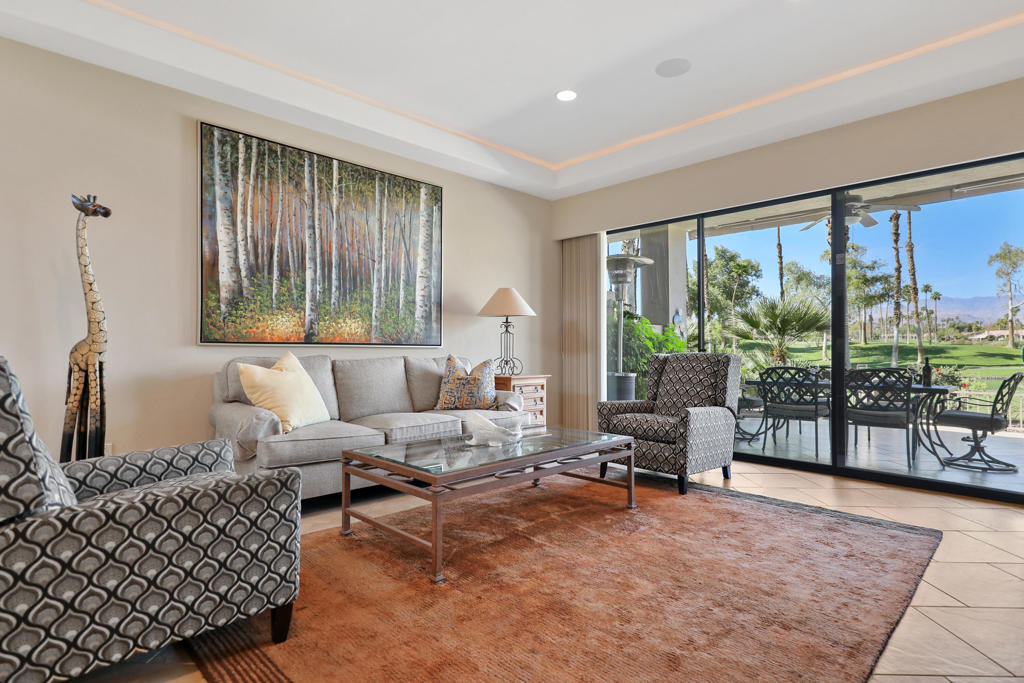 This beautifully updated 2-bedroom, 2.5-bathroom plus den condo is set in the best location in Palm Valley Country Club, offering unobstructed views of the majestic Jacinto Mountains and lush fairways. The den can be easily converted to a 3rd bedroom adding flexibility to accommodate your lifestyle. The open, sun-filled floor plan features vaulted ceilings, designer finishes, and a modern kitchen with granite & quartz countertops, custom cabinetry, and stainless steel appliances. A separate dining room provides a dedicated space for formal meals or entertaining, complemented by a bar area off the living room for added entertainment. The spacious primary suite includes the convenience of in-unit laundry, while the second bedroom is bright and inviting.Enjoy resort-style outdoor living with a private patio and additional courtyard, perfect for gatherings, relaxing evenings, or soaking in serene desert views.Additional highlights include updated flooring, recessed lighting, ceiling fans, and abundant storage, plus a dedicated parking space. Palm Valley Country Club amenities are second to none: two championship golf courses, 46 pools and spas, tennis and pickleball courts, a fitness center, and an active clubhouse for dining and social events.Whether you seek a full-time residence, seasonal retreat, or investment opportunity, this condo offers resort-style luxury, incredible value, and a prime Palm Desert location just minutes from El Paseo's shopping, dining, and cultural attractions.