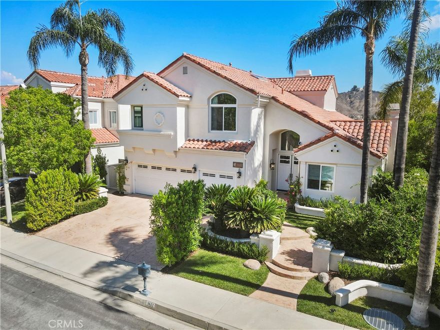 A treasure at the end of the rainbow! Welcome to this beautifully updated home in the prestigious guard-gated community of Calabasas Park Estates. Offering over 3,500 square feet of living space, this 5-bedroom, 5-bathroom home combines timeless elegance with plenty of modern upgrades. Abundant natural light streams through brand-new windows, highlighting soaring ceilings and spacious interiors. The thoughtful floor plan includes a downstairs en-suite bedroom that easily doubles as a private office, creating flexibility for today’s lifestyle. Designed for both everyday living and entertaining, the home features a formal living room, dining room, and an expansive great room with seamless flow to the backyard and breathtaking panoramic views. The chef’s kitchen is equipped with a large center island, generous counter space, Viking Professional appliances, a large Sub-Zero refrigerator, and a conveniently located breakfast nook. Traveling through the elegantly curved staircase, discover four well-appointed bedrooms, including a luxurious primary suite with serene views, a spa-like bathroom, and ample closet space. A second upstairs en-suite offers privacy, while two additional bedrooms share a convenient large bathroom. The backyard is an entertainer’s haven with a sparkling pool, spa, patio, and multiple areas for gatherings or quiet enjoyment. Additional highlights include a separate laundry room and a spacious three-car garage. Nestled on a tranquil cul-de-sac, this home blends comfort and scenic beauty in one of Calabasas’ most desirable communities.