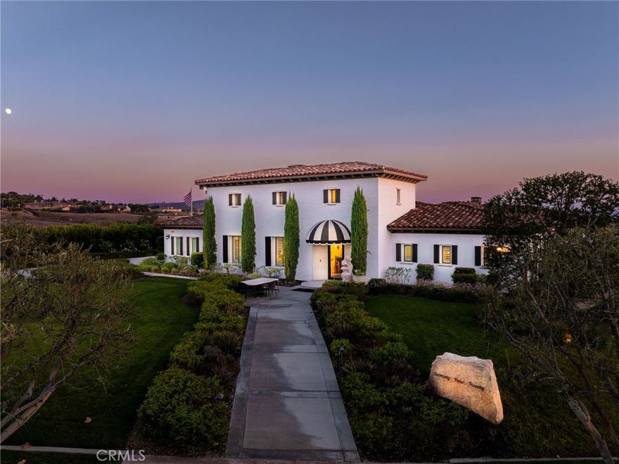 ALESSANDRO HEIGHTS- MONTECITO ESTATES- Entering the gates of this exclusive gate guarded community, you are greeted by pastoral mature Olive trees, white roses and city light/mountain views as far as the eye can see!  The soaring foyer of this impressive residence lures you into the elegant entry gallery with floor to ceiling glass windows affording views to the central courtyard with its fireplace and entertaining patio, also providing access to the separate guest suite as well as the home theater/self-contained ADU above.  The grand room moves seamlessly to the courtyard and the sunroom through retractable glass walls creating the ideal indoor/outdoor entertaining space all the way out to the pool.  The kitchen offers top-tier designer appliances including 3 ovens, commercial range with pot filler, 2 dishwashers and a Butler's Pantry with built-in Miele coffee/espresso maker. Two massive islands provide ample meal preparation and serving surfaces on the pristine white quartzite counter-tops;  Separate wine storage room and large walk-in pantry.  The separate dining room accommodates any large party with stunning details and views of the surrounding hills;  Separate family room/music room with views of the pool and city lights with soaring beamed ceiling and elegant fireplace; An office/library is located off the entry gallery affording views of the courtyard as well as the city lights.  The primary bedroom suite is sequestered and contains the luxurious bedroom area with sitting area and fireplace, opulent spa-like white marble bath with walk-in shower, free-standing tub and dual vanities;  Dual "boutique style" walk-in closets designed to insure optimal organization of all your clothing shoes and accessories in their designated spaces.  The additional 4 large bedrooms for a total of 5 all have their own distinct ensuite baths and walk-in closets.  The upper level contains the home theater with seating for 10 as well as a fully self-contained ADU with kitchenette, bedroom and spacious bath.  Massive indoor laundry accommodates dual launder sets and loads of storage.  The grounds perfectly encompass the residence with pristine landscaping providing ample privacy without impeding the incredible views enjoyed from the site!  The classic pool with spa and water feature is surrounded by expansive decking and lawns evoking a rich European inspired scene which is additionally complimented by the private orchard of Avocado, Lemon and Naval Orange Trees!