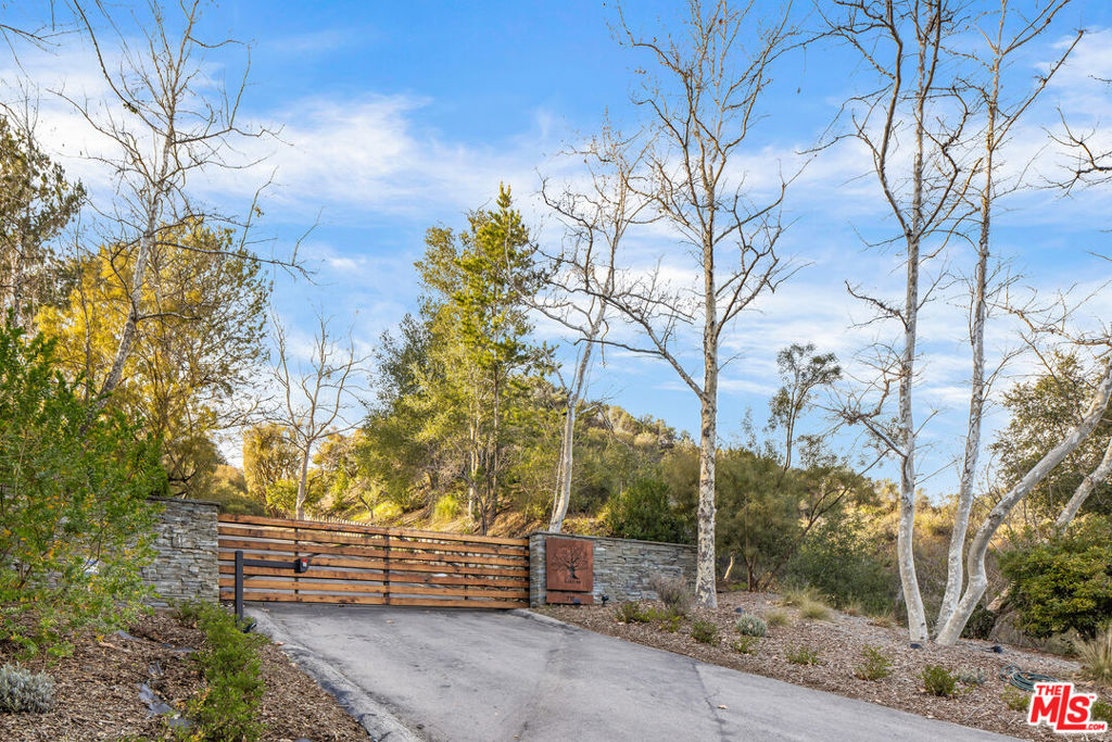 Oaktree Ranch is a stunning 19-acre equestrian estate conveniently located just 10 minutes from the Malibu business district and the 101 freeway. Upon entering the gated estate, you'll be greeted by a meandering road that winds through towering oak trees, leading to the Mark Rios-designed manor house. The sumptuous primary suite is located alone on the second floor and features an office, two state-of-the-art bathrooms, and two spacious closets. Two additional bedrooms with ensuite bathrooms are located on the main level, along with a gym, office, living room, dining room, and fully equipped kitchen. Outdoor amenities include a swimming pool with a cabana and BBQ area, and a lighted tennis court, perfect for enjoying the beautiful California weather. For those with an equestrian passion, there is an 8-horse stable with a stable manager's office, two corrals, a chicken coop, a pigeon coop, goats, ducks, and ponies. At the entry to the property, there is a 4-bedroom guest house or caretaker's home, providing additional space for visitors or staff. Oaktree Ranch offers the ultimate equestrian estate experience for those seeking privacy, tranquility, and a connection to nature, while still being in close proximity to the community. It's the perfect retreat for those wanting to get away from it all while enjoying the best of both worlds.