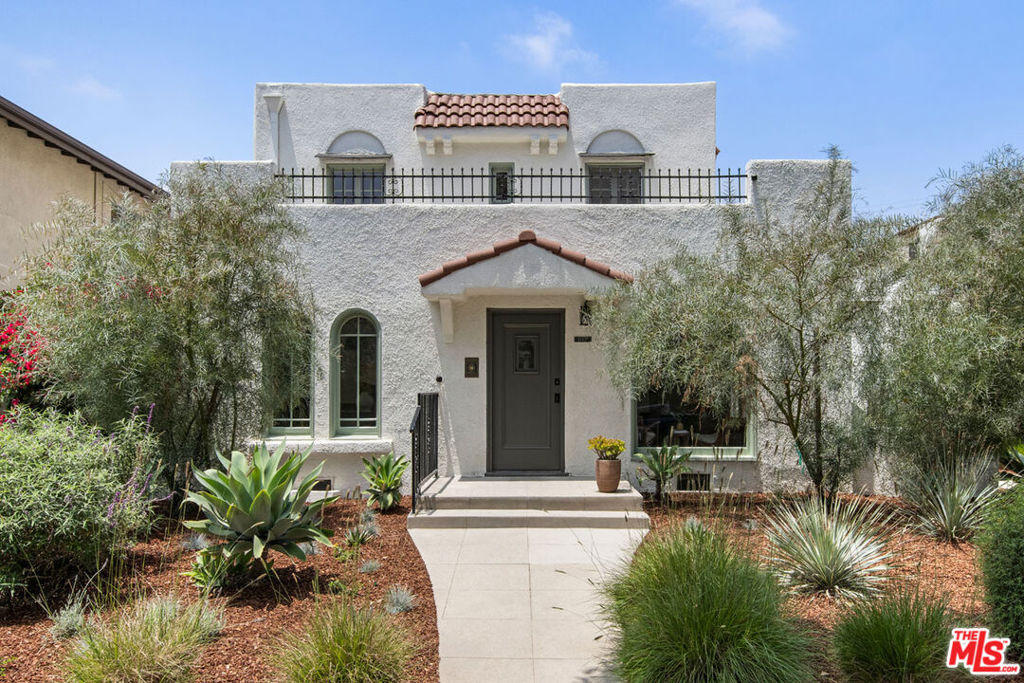 New Co-Ownership Opportunity: On a quiet street just off Melrose in Hancock Park, a rare chance to own a piece of LA's architectural history: a beautifully restored 1926 Spanish two-story TIC set within a designated Historic-Cultural Monument bungalow court. The coveted front residence has been revived with an eye for detail to highlight heritage charm and integrate modern updates, including refurbished original wood floors, hand-painted Mexican mosaic tiles, and recessed lighting. Arched windows gather sunlight into the spacious living and dining area, where a decorative fireplace anchors the vintage-inspired design. The kitchen is tailored for design-savvy cooks, with matte zellige backsplash, hand-painted cabinetry, and a KitchenAid suite with wine fridge. Upstairs, both bedrooms get great light, and the bath is exquisitely redone with high-end fixtures. Native California flora wraps the home; amenities include smart lighting, AC/Heat, and parking. Close to The Grove, Tartine, HEIMAT & WeHo favorites.