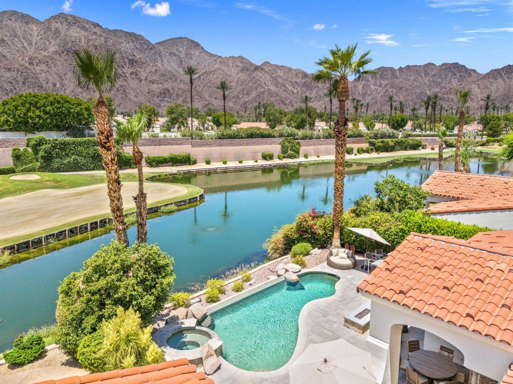 This is the perfect desert retreat for those seeking luxury, convenience, and an un-beatable lifestyle. Featuring 4-bedrooms with separate 2-room casita nestled on a premium lot along the golf course in the gated community of Haciendas at La Quinta. This architecturally refined home offers the ultimate in elevated desert living, with sweeping views of the golf course and surrounding mountains, creating a breathtaking backdrop. The heart of the home is a gourmet chef's kitchen, thoughtfully designed. Outfitted with top-of-the-line designer appliances, including a Sub-Zero refrigerator, wine storage, Wolf range. The Custom cabinetry has glass features and pull outs, Premium Calacatta Quartz jumbo slab countertops, and a large island provide both elegance and function, with all new lighting. This space is ideal for entertaining or intimate gatherings! Each space within the home reflects attention to detail. with high-end luxury finishes, custom built-ins, window treatments, and designer touches throughout. The great room open-concept living seamlessly connect indoor and outdoor spaces, with vaulted ceilings, wood beams and a cozy fireplace. Step outside to your own private resort-style oasis, featuring a salt water pool, spa, firepit, built in BBQ, and panoramic vistas of the lush golf course and majestic mountains. Other features of this home are the Primary bedroom with a king sized bed and views to the beautiful backyard, the primary bathroom has a large walk in shower and soaking bathtub with dual vanity sinks. Primary walk in closet with custom built in features, The guest bedroom on the opposite side of the home has complete privacy and features a Queen bed and its own private remodeled en-suite. The Den which flows off of the kitchen is a great work from home-office and has French- Doors for total elegance. The Separate 2-room casita features a living area, en-suite, and a separate bedroom with another King sized bed, Coffee Bar area with microwave & refrigerator. This Home is Ideally located in the heart of La Quinta, walk or bike to Charming Old town LQ, The famous La Quinta Resort & Spa, close by are world -renowned golf courses, top-rated restaurants, & vibrant entertainment, hiking and biking trails are just minutes away. And for shopping visit the famous El Paseo shopping and entertainment district. Call me for a private showing of this luxurious vacation escape.Available Fall 2025 and Season 2026!