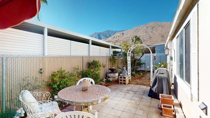 Nestled in the vibrant Palm Springs Mobile Home Club, this 2-bedroom, 2-bathroom manufactured home offers comfort and convenience in a prime location. Featuring an open floor plan, the home boasts a spacious living area with a cozy fireplace and abundant natural light from large windows. The well-appointed kitchen provides ample storage, a breakfast bar, and adjacent dining space, perfect for gatherings. The primary suite includes an en-suite bathroom with dual sinks, a soaking tub, and modern lighting.Outside, enjoy the mountain views from the private patio or take advantage of the carport with parking for two vehicles. The community amenities include a sparkling pool, clubhouse, Dog Park and beautifully maintained grounds. With its central location, this home is close to Palm Springs' iconic shops, restaurants, and entertainment, offering the perfect blend of tranquility and accessibility. Experience the charm of Palm Springs living today!