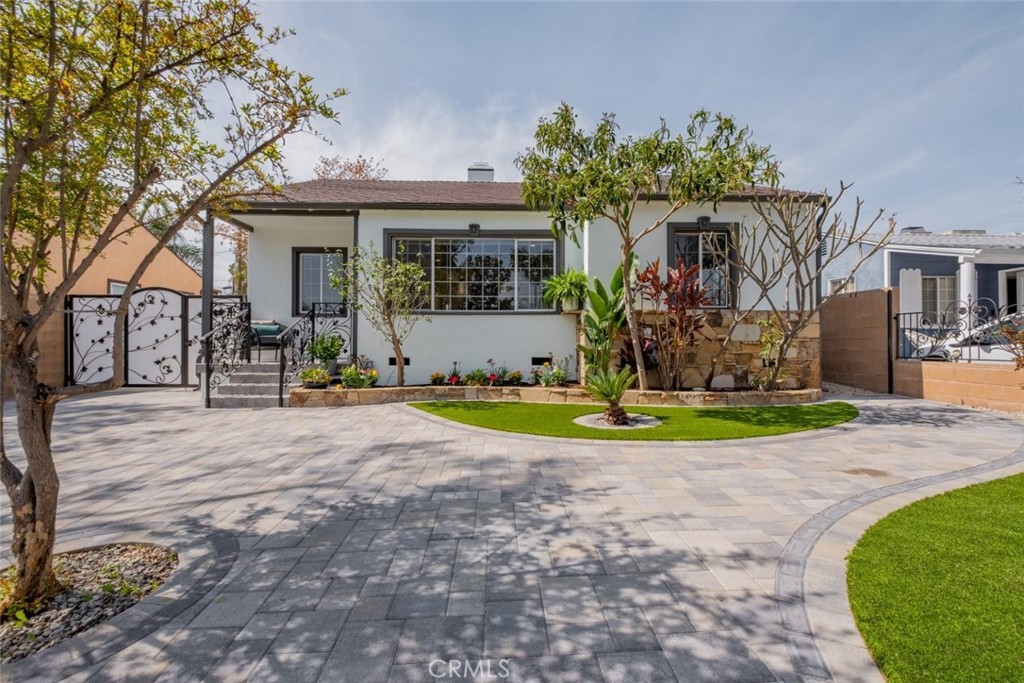 Discover this fully remodeled gem in the highly sought-after Magnolia Park neighborhood. Thoughtfully updated, this stunning home features recessed lighting, a brand-new HVAC system, new gutters, new doors, and a new roof - all designed for effortless living.
The inviting living room showcases a striking green marble multi-sided fireplace as its centerpiece. Refinished hardwood floors and graceful arches lead to a custom kitchen with a charming breakfast nook and a separate dining area. Two cozy bedrooms share a luxurious bathroom with a clawfoot tub, marble walls, and a spacious vanity.
The dining area opens to a serene covered deck overlooking a private, low-maintenance paver stone backyard - large enough for entertaining and perfect for relaxing among the fruit trees. The property is fully fenced with center block walls and gated in the front, providing both privacy and security.
Adding incredible value, the residence offers a total of 2,012 sq ft of living space, which includes a renter-ready 746 sq ft two-story detached ADU complete with a full kitchen, fireplace, recessed lighting, air conditioning, and new laminate flooring. The oversized balcony features beautiful mountain views, while a dedicated laundry room with a sink adds convenience.
The detached 2-car garage (371 sq ft) boasts tile flooring, electricity, hot and cold water, and gas pipelines - making it perfect as a bonus room, game room, or potential conversion to additional living space.
Beyond the gate, enjoy a lush variety of fruit trees including mandarin, kumquat, orange, fig, loquat, grapefruit, and pomegranate. This prime location is within walking distance of top-rated Burbank schools, the library, and a local park.
Every detail of this home has been meticulously crafted with care. Do not miss this exceptional opportunity.