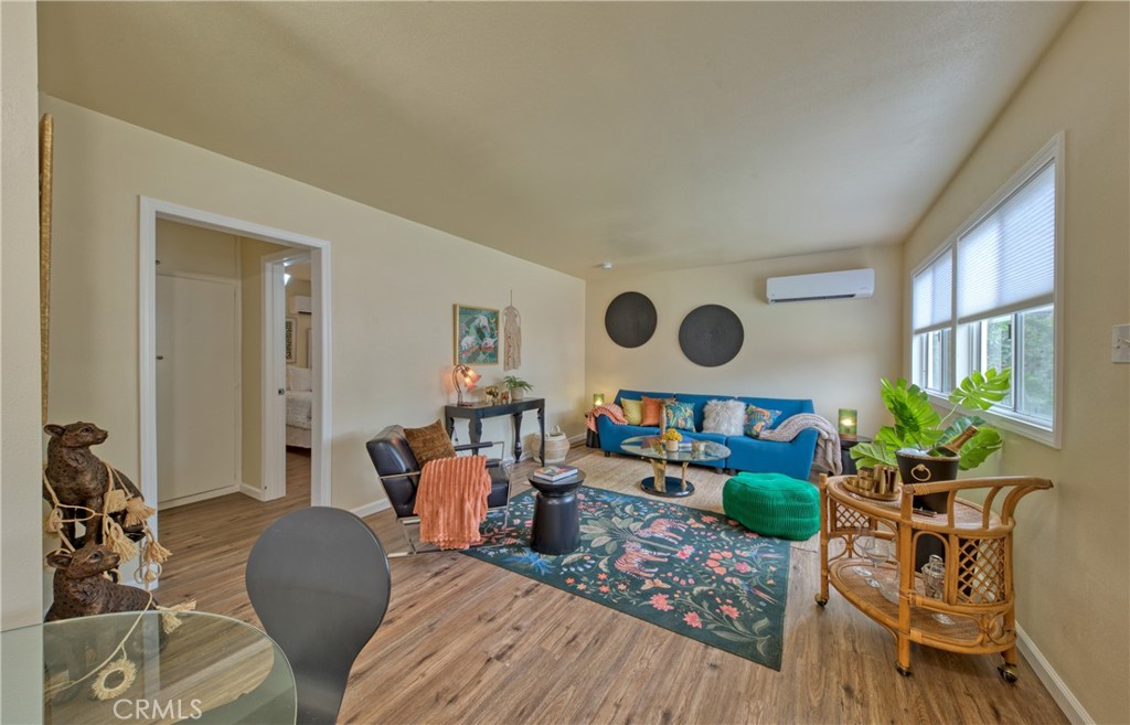 This well-maintained triplex presents a unique opportunity for an owner-occupant or an investor looking to add a quality asset to their portfolio. The property features two connected, side-by-side units, each with one bedroom, a full bathroom, a living room, and a kitchen. Both units are equipped with wall window AC units for comfort. The third, vacant and detached unit has been recently remodeled and is ready for its new resident. This unit offers a spacious and open layout with a bright living room, a separate dining area, and a well-appointed kitchen with a stove. It includes two generously sized bedrooms, a full bathroom, and modern amenities like an in-unit stackable washer and dryer, new vinyl flooring, and energy-efficient mini-split systems for heating and cooling. Ideally situated a short distance from the vibrant Old Town Monrovia, offering easy access to a variety of shops, restaurants, the public library, and local parks.