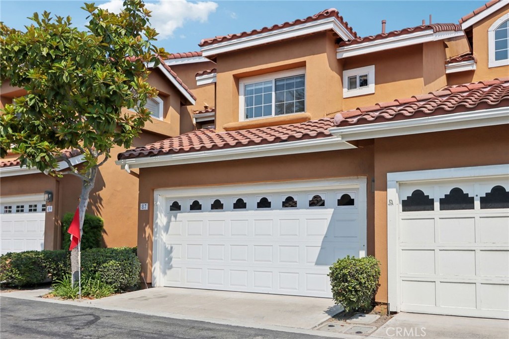 RECENTLY UPDATED TOWNHOME WITH ALISO VALLEY & SADDLEBACK MOUNTAIN VIEWS. Welcome to this beautifully refreshed two-story townhouse in the highly sought-after gated community of Provence D'Aliso. Perfectly situated near the rear of the community, you will enjoy captivating views of Aliso Viejo and stunning sunrises over Saddleback Mountain from your private patio and balcony. This home is also conveniently located above the highly rated Aliso Niguel High School with walking access to the school. Inside, you’ll love the spacious open floor plan with a bright foyer leading into the living room, complete with a cozy fireplace, recessed lighting, and large windows that flood the space with natural light. The adjoining dining area flows seamlessly to the updated kitchen, now featuring new quartz countertops, new large porcelain sink, new stainless-steel dishwasher, new range venting, and stainless-steel refrigerator. This townhome also has a new Spanish tile roof providing security and maintenance free living for years to come. The lower level has been enhanced with new luxury vinyl plank flooring for that modern appeal, while upstairs features all new carpet. Additional upgrades include central air, mirrored closet doors, and in the primary suite, new double-sinks and quartz vanity countertop. The garage has a newer garage door and opener as well as new epoxied floor. These thoughtful updates make the home truly move-in ready. From the dining room, step through the sliding glass door to a large private rear patio with planters and mature trees—perfect for dining, entertaining, or simply enjoying peaceful moments with friends and family. The main floor also offers a powder room and the convenience of direct access to the two-car attached garage which also includes a laundry area. Upstairs, a generous loft provides space for a den, office or easy conversion to a third bedroom. The spacious primary suite boasts vaulted ceilings, a walk-in closet, and a refreshed en-suite bathroom. Completing the upper level is a second bedroom with French doors leading to your private balcony with breathtaking views and a full bath. Residents enjoy resort-style amenities including a pool, spa, and tennis courts. Award-winning schools, Aliso Viejo Town Center’s shops and dining. You will appreciate a direct walking path to Hillview Park for the spectacular views of the valley. Don’t miss your chance to own this beautifully updated home in one of the most desirable communities!