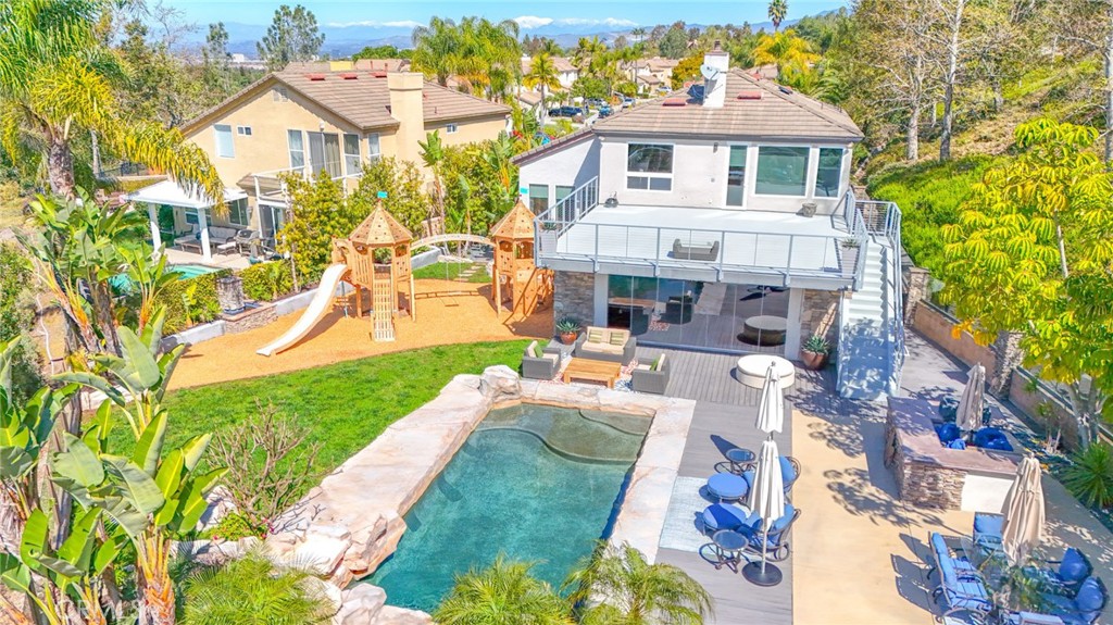 Turnkey Property. GREAT FOR ENTERTAINING. Property on one of the LARGEST LOTS(16,172 sq. ft.) in Aliso Viejo. Backyard has a Stunning Rock Surround Pool & Spa & Water Fall, Multiple Fountains , a Sports Court, Built in BBQ Island, Fire Pit, CeadarWorks Play Set, Canyon Views and More. Located at the End of a Long Cul-de-Sac the home is set back with a Long Driveway(at least 6 cars could fit with room to spare) The Large Entry Courtyard is surrounded by Custom Wooden Gates(Custom built by Garden Passage), Glass Walls and extensive Masonry. Entering the 2,824 sq. ft. HOME you see Two Story Ceilings and Custom Full Length Windows to take advantage of the Canyon Views. Schonbek Crystal Chandeliers in almost all rooms throughout the house. Enjoy the Office/Bedroom and Full Bathroom with river rock shower on the First Level. UPGRADED KITCHEN(with two walk-in pantry’s) opens up to Enormous Family Room with Accordion Style Glass Doors that truly brings the inside out looking at the Rolling Hills of Laguna Beach. Heading upstairs you enter the Master Bedroom through the Double Door entry to Commanding Views and Access to the approx. 900 sq. ft. roof deck to enjoy endless sunsets, entertaining or Dinner with Friends. The Master Bath is Open and Bright with a glass enclosed Shower, Large Tub and Duel Vanities. Two additional Bedroom, Large Bathroom and Loft are all nearby. Location is Perfect. Just Minutes from Downtown Laguna Beach and next to the 73 toll road for quick access to Newport, San Juan Capistrano and Irvine Spectrum. This property has to many upgrades to mention. Please see list in Supplements for Greater Detail.