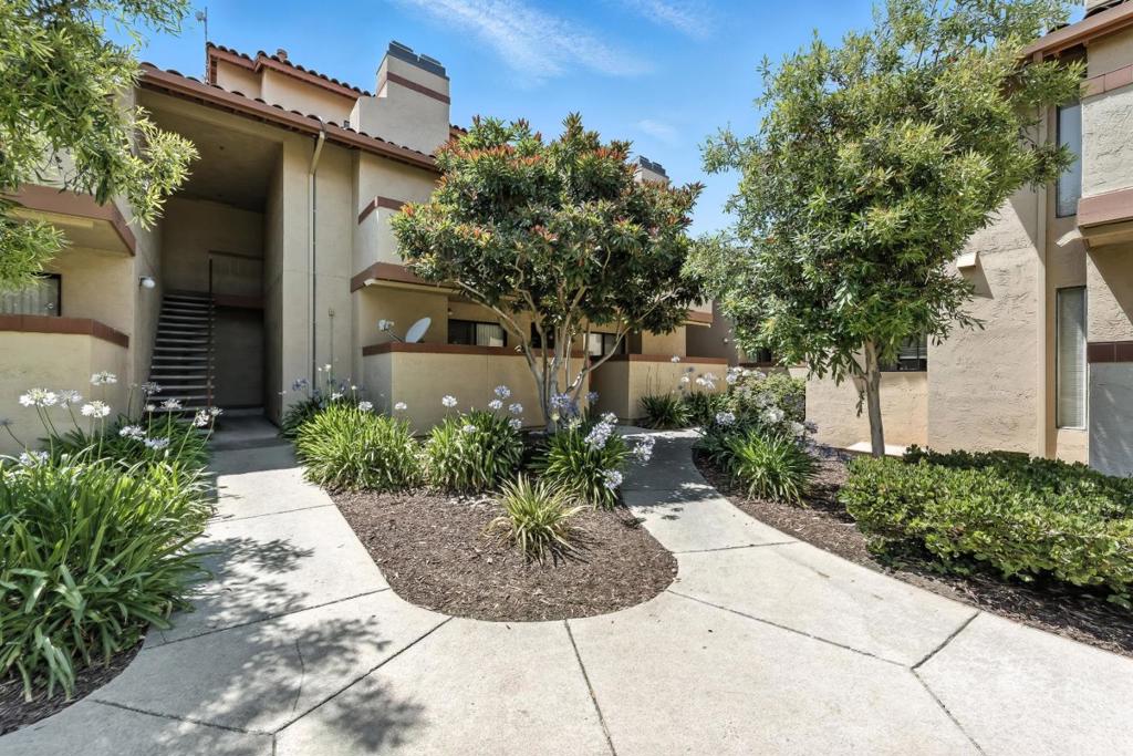 Top Two Floor Cupertino Condo, Convenience Abounds This delightful condo, located on the top two floors of a three story building, has abundant convenience. It is located only a short walk away from the Homestead Shopping Center, is walking distance to multiple parks, even walking distance to De Anza College, and has easy access to commute routes. Apple is only 2.3 miles away. If you like to go on hikes, Stevens Creek County Park is less than 5 miles away. This home has a partially open floor-plan with the kitchen, dining room and living room all open to each other. A vaulted ceiling, a sliding glass door opening to a large balcony, and clerestory windows create an open, light filled, space. Wood laminate flooring with a hand-hewn surface add a natural feeling to a bright modern design. The bright cheerful kitchen features modern appliances and architectural features such as a cove ceiling. The upstairs floor has a bedroom and a bathroom providing a tranquil area. Both bathrooms have a modern design and modern fixtures.