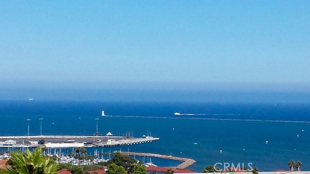 Unobstructed, panoramic views of the ocean, harbor and mountains from this front buildings corner penthouse end unit. Rarely available top floor 2bed, 2 bath in Bay View Terraces in the Palisades of San Pedro. One shared wall. Remodeled kitchen with custom cabinets, quartz countertops, stainless steel appliances, recessed lighting, tile flooring. Upgraded energy efficient double pane windows that will keep you cool in the summer, warm in the winter and whisper quiet when closed. Spacious primary bedroom with en suite bath, frameless glass shower and modern finishes. Second bedroom is generous in size. Beautiful engineered hardwoods, tile, vinyl (guest bath). Freshly painted. In unit laundry with Speed Queen washer and dryer. The unit comes with 2 side by side parking spaces and overhead storage. Complex amenities include: pool, spa, gym, free high speed internet (1gig!), beautiful grounds. Conveniently located near Cabrillo Beach Point Fermin, Korean Friendship Bell and the new multi million dollar development West Harbor. Don’t miss this rare opportunity for a view that will bring you decades of peace and relaxation as you gaze over the ocean.