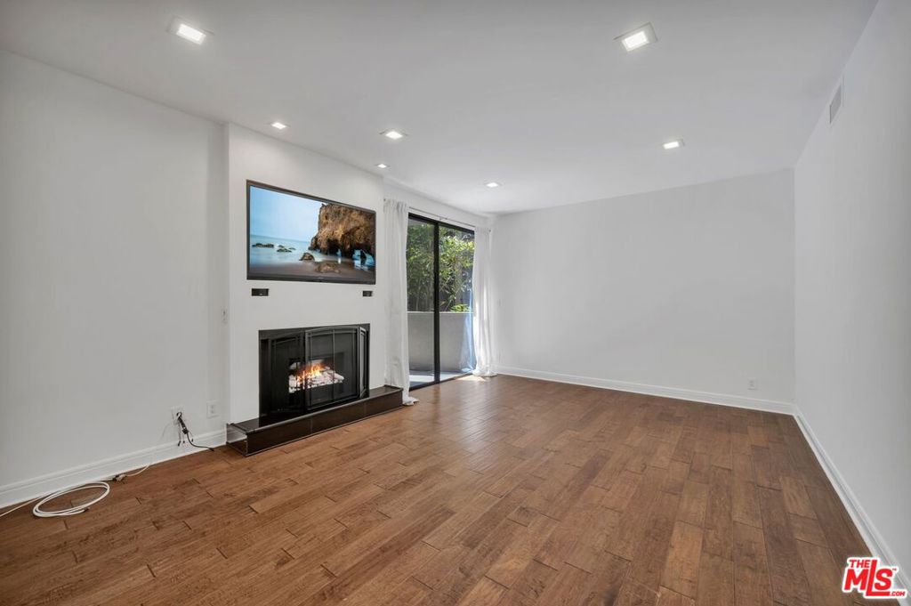 Welcome to the highly sought-after Fountainview complex, where resort-style amenities and timeless elegance come together right in the heart of West Hollywood. From the moment you enter the beautifully appointed lobby, you'll feel as if you've stepped into a luxury hotel. This spacious and stylish 2-bedroom, 2-bath condo features rich wood plank flooring and slate tile throughout. The sunken living room offers a dramatic slate fireplace and opens to a generously sized private patio, perfect for relaxing or entertaining. The chef's kitchen is a dream, complete with stainless steel appliances, warm stone countertops, and a chic tile backsplash.The oversized master suite includes a spa-style en-suite bathroom and a walk-in closet. Both bedrooms are well-proportioned with excellent natural light and storage.Enjoy premium amenities including a sparkling swimmer's pool, two spas, a state-of-the-art gym, and men's and women's poolside restrooms with private dry saunas. Secure building with gated side by side parking and close proximity to West Hollywood's best dining, shopping, and nightlife just minutes from the iconic Sunset Strip.
