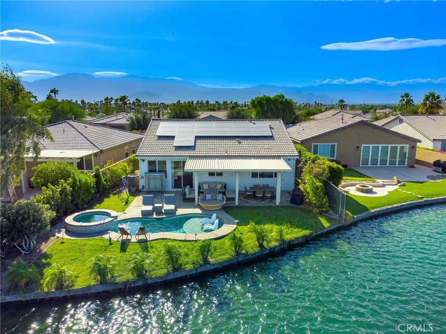 WOW... Lowest Priced Lake Front Home!Terra Lago Lake One Story Detached Pool/Spa Home by Woodside, Former Model. Featuring 4 bedroom, 3 beautifully updated baths with East Facing Leisure view of Lake, Mountains and Terra Lago's Signature bridge. Updated Chef's Kitchen with center island, quartz counter tops, Newer Stainless Steel appliances, Fridge Included. Spacious Great room, dining area. The primary bedroom offers Lake, Mountain view! Walk in closet, the large ensuite primary bath offers updated vanity with dual sink, separate tub and shower. 3 Guest Bedrooms all with walk in closets. Built in speakers. Sep outside to the private large entertainers back yard with grass area, salt water pool & spa, Recent upgrades include newer laminated flooring and paint throughout, Solar, tankless water heater, newer AC System! Aluma wood patio cover with misters. Great Location, walk to Clubhouse, easy access to Avenue 43 gate for shopping, dining, entertainment, nearby New Acrisure Arena for awesome concert events, Ice Hockey and more! Terra Lago allows Short Term Rentals.  Resort Style Living At Its BEST!!!