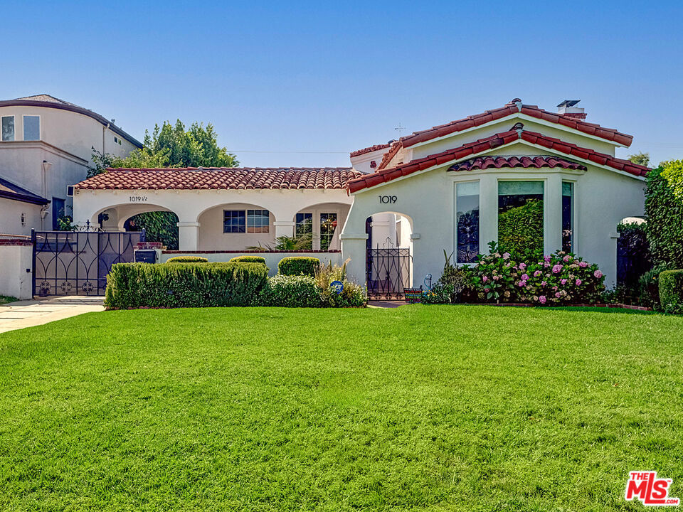 SALE SUBJECT TO BANKRUPTCY COURT APPROVAL AND OVERBID! At 1019 S Rimpau Boulevard, a rare alchemy has been achievedthe seamless integration of 21st-century sophistication within an authentic Spanish Revival framework. This distinguished residence near Hancock Park exemplifies the art of preservation through thoughtful evolution, where original architectural character has been meticulously honored while every modern comfort has been artfully incorporated. Throughout the main residence, gleaming hardwood floors create rivers of warmth beneath soaring ceilings punctuated by recessed lightinga subtle nod to contemporary living that never overshadows the home's inherent grace. The living room's original fireplace remains the heart of the home, now enhanced by refined surroundings that speak to both past and present. The primary suite epitomizes California's indoor-outdoor ethos, where French doors frame verdant views of the rear grounds. The en-suite bath has been transformed into a spa-like sanctuary, featuring a double-sink vanity, standalone soaking tub, and separate shower modern luxuries nestled within timeless architecture. The property's ADU represents contemporary living at its finest, where floor-to-ceiling corner sliding doors dissolve the boundaries between interior and exterior spacesa dramatic architectural gesture that transforms the unit into a luminous pavilion. Pristine tile flooring, quartz countertops, and stainless steel appliances create a sophisticated residence, while a split AC system ensures year-round comfort. Recessed lighting maintains the clean aesthetic throughout this seamlessly integrated indoor-outdoor living space. Beyond the interior spaces, the rear yard has been reimagined as an entertainer's paradise. A expansive patio deck flows seamlessly into an outdoor kitchen complete with grill, refrigerator, and sinktransforming al fresco dining into an art form. The sparkling pool and spa, nestled within mature landscaping, create a private resort atmosphere. Minutes from Larchmont Village's boutiques, LACMA's galleries, and the retail sophistication of The Grove and Beverly Center, this residence offers both sanctuary and accessibility. The nearby Petersen Automotive Museum and Hollywood studios place you at the epicenter of Los Angeles culture. This is Spanish Revival living evolvedwhere the romance of old Hollywood architecture meets the demands of contemporary life, proving that honoring the past and embracing the future need not be mutually exclusive.