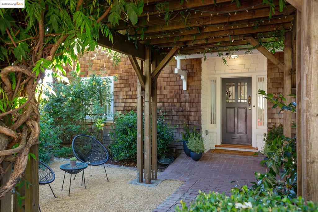 Tucked behind a handcrafted redwood pergola and a 60+ year-old wisteria vine, this beloved 1909 home blends historic charm with modern comfort. Lovingly cared for by the same family for over three decades, it tells a story—of fireside gatherings, holiday meals in the chef’s kitchen, and garden conversations with neighbors passing by. Renovated in 2020 with respect for its character, it retains hardwood floors, French doors, and built-in bookcases, paired with radiant floor heating, Marvin windows, custom Crystal cabinetry, and premium appliances including a Fulgor Milano range and Miele dishwasher. The main level glows with light and offers a breakfast nook with built-in bench, home office, and sunny flex room opening to an expansive deck for morning coffee or sunset wine. Downstairs: three en-suite bedrooms, laundry, and a private suite with separate entrance and kitchenette—ideal for guests or in-laws. Two outdoor areas feature Japanese maples, fruit trees, and raised beds ready for your green thumb. All this just 3 blocks to Piedmont Avenue’s vibrant offerings, with a 91 Walk Score and quick I-580 access.