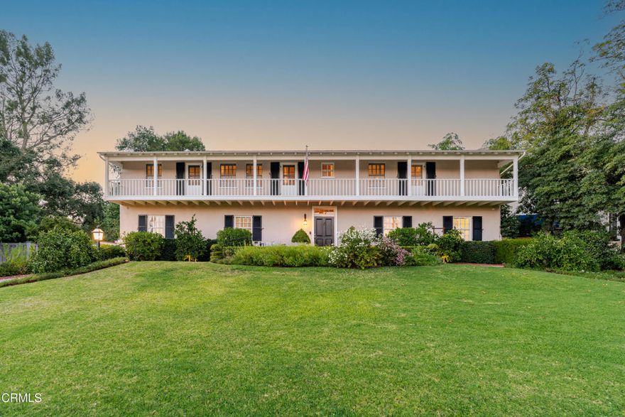 Following the palm trees to the mountains is where you'll find this grand Monterey Colonial residence located on what has always been Altadena's most iconic street. Meticulously maintained by the same family for 28 years, this home is truly a treasure. The sweeping front yard, with mandarin and avocado trees, welcomes you home. Gleaming hardwood floors greet you at the front door and flow throughout the house. A formal entry leads into the living room, with beamed ceiling, crown moldings and a beautiful fireplace anchoring the room. Nearby is a cozy office with a brick fireplace, which makes for an ideal space to work from home. A spacious formal dining room provides a great setting for dinner parties and flows to the kitchen and family room. The updated kitchen has a large island with counter seating, plenty of cabinets for storage and a wine refrigerator. Vaulted ceilings, bookshelves and a fireplace make the family room a comfortable spot to relax while being close to the kitchen. A powder room completes the first floor. All main floor rooms have french doors that exit to the rear patio, ideal for entertaining. Upstairs is the sizable primary ensuite bedroom, with two walk-in closets and attached bathroom with two vanities. Two spacious bedrooms with large closets share a stylish hallway bathroom. All 3 bedrooms have doors to the second floor balcony that runs the length of the home. The backyard has an expansive brick patio, mature lemon and apple trees, and a lush garden, the perfect place for dining outdoors and enjoying the evening breeze. A 2-car garage is attached with a utility sink, 220v outlet, and plenty of storage cabinets. The home is close to the Altadena Town and Country Club, Prime Pizza, Armen Market and so much more.