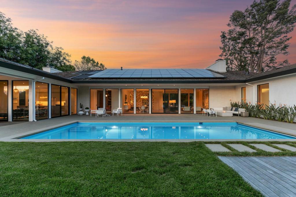 Reimagined from top to bottom, this home has been artfully transformed inside and out into chic designer style while maintaining the original mid-century modern aesthetic. The whole-home renovation, with architecture by owner Melanie Thibault of Charlie Barnett Associates, is an absolute masterpiece with attention to detail that is second to none. White oak hardwood floors unify flowing spaces that predominantly span one level, custom cabinetry is often floating for contemporary panache, and tile and quartz selections are five-star. Ceiling heights reach 10 feet in the main living areas with entire walls of glass that invite seamless indoor/outdoor living.