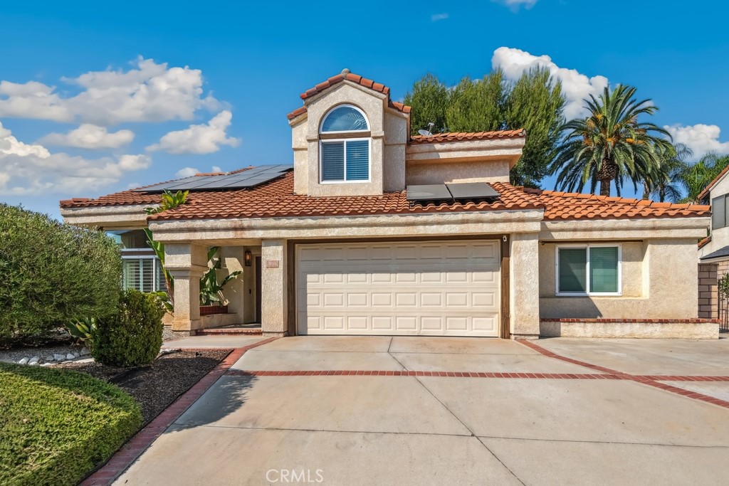Move-in ready 3 bed, 2.5 bath home featuring fantastic curb appeal, with mountain views, and OWNED Solar Panels! The interior is very spacious with soaring 2-story ceilings, recessed lights, plantation shutters, and waterproof vinyl flooring in the main living areas. Enter the home through double doors into the stunning formal living room and dining room with semi-circle staircase and chandeliers over the entry and dining area. The kitchen sits just off of the dining room and offers breakfast bar seating, quartz countertops with matching backsplash, an stainless steel appliances. The light and bright family room sits just off of the kitchen and offers glass french doors to the backyard as well as a fireplace, and a half bathroom and the laundry room complete the 1st floor. All of the bedrooms are located on the 2nd floor including the massive primary suite with private fireplace and a spa-like ensuite which features a dual sink vanity, a soaking tub, a separate shower and a large walk-in closet. There is also a full-size hall bathroom for the 2 secondary bedrooms to share. Relax and entertain in the private backyard with covered patio that spans the length of the home, lush green grass, and well manicured landscaping. There is also an XL 721 Sqft 2-3 Car Garage and an expansive driveway that can accomodate a boat or RV! Conveniently located near Prado Park, trails, schools, shopping, dining, and not far from the 215 Fwy! Come and tour today!