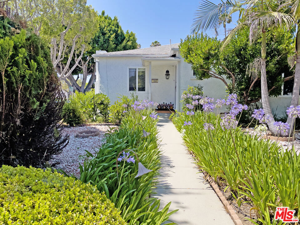 Located north of Wilshire in one of Santa Monica's most sought-after neighborhoods, this charming single-family home has been lovingly maintained by one family for nearly 40 years. Situated on a spacious corner lot perfectly situated for natural light to flood the inside of this 2 bedroom, 2 bathroom home plus a bonus room. The light-filled interior features newer flooring and a modern open-concept layout. The updated kitchen, complete with a center island, flows seamlessly into the living and dining areas, perfect for everyday living or entertaining. The bonus room/office offers flexible space and may not be reflected in the total square footage. An attached garage allows direct access into the house. A private, enclosed backyard with mature fruit trees, a storage shed, and plenty of room to relax or garden. This unbeatable location is just minutes from Whole Foods, Trader Joe's, Erewhon, and many of Santa Monica's most popular dining spots. Just blocks from Douglas Park and top-rated Franklin Elementary and Lincoln Middle School, with convenient access to UCLA Santa Monica Medical Center and St. John's Hospital. Great opportunity for remodeling or build new. Refrigerator, W/D are excluded. Fireplace is decorative only. Property is being sold in as-is condition. No credits or repairs.