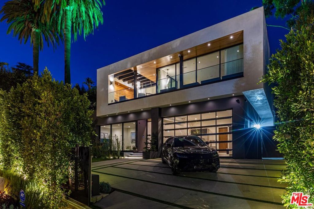 Experience luxury living in this fully customized modern smart home, privately set behind gates just north of Sunset Boulevard. Designed by world-renowned interior experts, this home showcases exceptional details throughout from bespoke wallpaper and Venetian plaster walls to handcrafted closets and a state-of-the-art security system. Entertain effortlessly with a sleek media room, climate-controlled wine storage, and an expansive rooftop deck featuring a second spa and sweeping views from the Sunset Strip to the Pacific Ocean. Floor-to-ceiling glass walls open to a breathtaking zero-edge pool and spa, creating a seamless flow between indoor and outdoor living. Thoughtfully designed for both grand entertaining and private relaxation, this home offers the ultimate in style, comfort, and exclusivity.