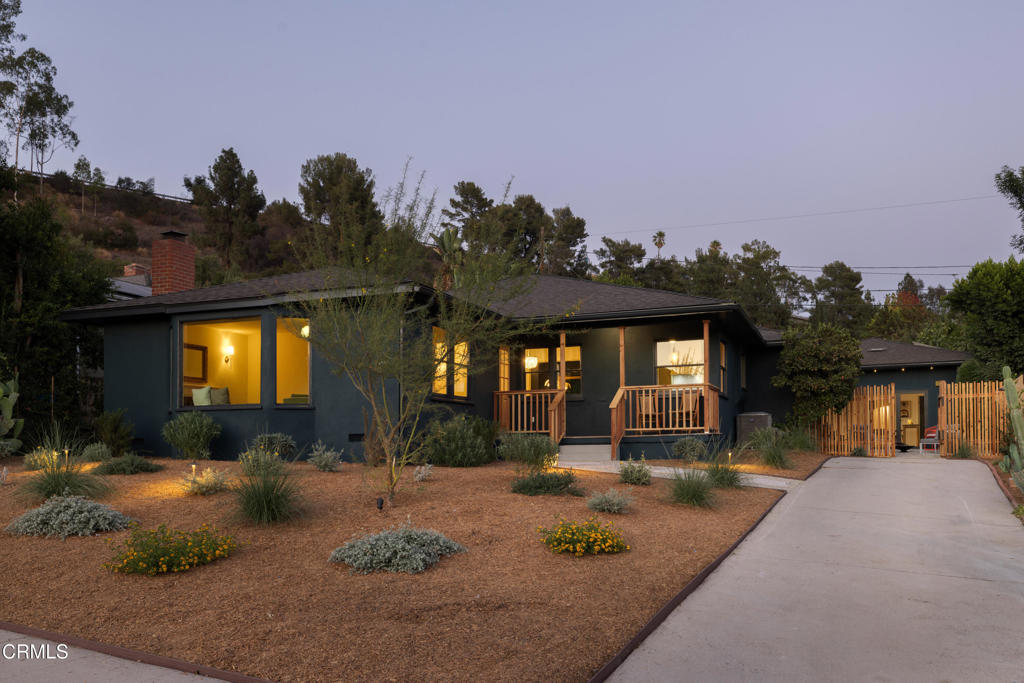 Tucked into a coveted pocket of Eagle Rock, this thoughtfully reimagined 1950s California compound blends timeless design with modern updates. The main house offers 3 bedrooms and 2 bathrooms, while the converted garage provides a flexible 1 bed/1 bath guest house; ideal as a studio, workspace, or in-law suite. Natural light floods the expansive living room through a large bay window, with a stately decorative fireplace grounding the space. Restored wood floors and original windows preserve the home's mid-century character and craftsmanship. The formal dining room flows into a beautifully renovated kitchen, perfect for hosting holidays or everyday meals. Marble countertops with coved edges, custom cabinetry, and a sunny breakfast banquette create a warm, functional centerpiece for the home. The den and main bedroom wing feature a rich, dramatic palette, adding depth and sophistication. The primary suite includes a walk-in closet, jewel-toned shower, and direct access to the backyard. Two spacious guest bedrooms and a stylish shared bath complete the main residence. Outside, enjoy a private backyard retreat with mature landscaping, a sparkling pool, and plenty of space for dining, relaxing, and entertaining. Located north of Colorado Blvd near Dahlia Heights Elementary, you're just blocks from Eagle Rock's favorite shops, cafes, and hiking trails.
