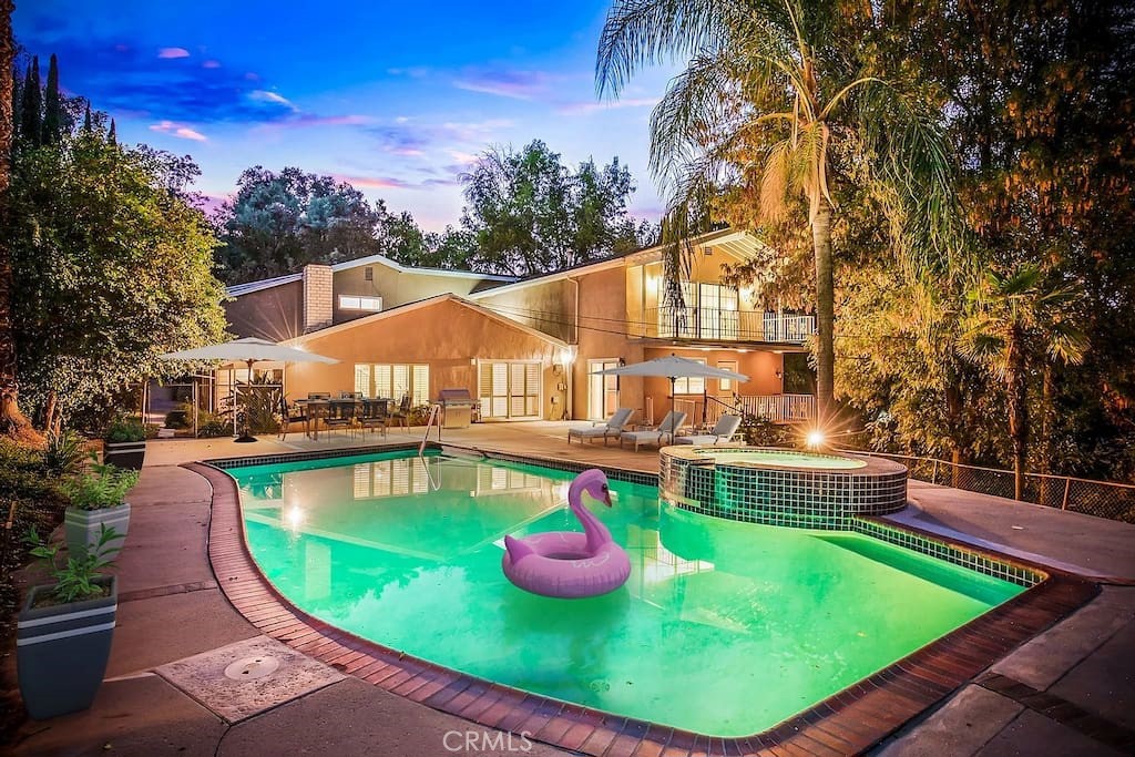 SHORT SALE - Submit All Offers
Welcome to this luxurious and spacious 8-bedroom, 6.5-bathroom estate located on a considerable lot in the sought-after Woodland Hills area. Spanning over 5,500 square feet, this retro-chic home is perfect for families, professionals, or anyone needing comfortable and upscale mid-term housing. With its unique amenities, dual kitchens, and serene setting, this home truly stands apart.
Key Features You'll Love:
Two Full Kitchens: Perfect for large families, groups, or extended stays, each kitchen is fully equipped with appliances, ample counter space, and storage for all your culinary needs.
Game Room & Bar: Enjoy a dedicated game room complete with a built-in bar, making it the ultimate entertainment hub for hosting or relaxing.
Smart Home Technology: Stay comfortable and secure with smart thermostats, smart locks, and video security systems.
Bonus Room: A versatile additional room that was once a music studio, ideal for a creative workspace, fitness area, or additional storage.
Ample Parking: Includes a two-car garage and plenty of additional driveway parking.
Private Outdoor Oasis: The oversized lot features a beautiful pool, outdoor seating areas, and lush greenery for ultimate relaxation.
Designed for Comfort & Convenience:
Large Bedrooms & Bathrooms: Each bedroom is thoughtfully furnished with plush bedding and ample storage, while the bathrooms provide a spa-like retreat.
Prime Woodland Hills Location:
Nestled in a tranquil neighborhood, this home offers easy access to local attractions, including:
Topanga State Park and nearby hiking trails.
Shopping and dining at The Village at Westfield Topanga.
A short drive to Malibu beaches and the greater Los Angeles area