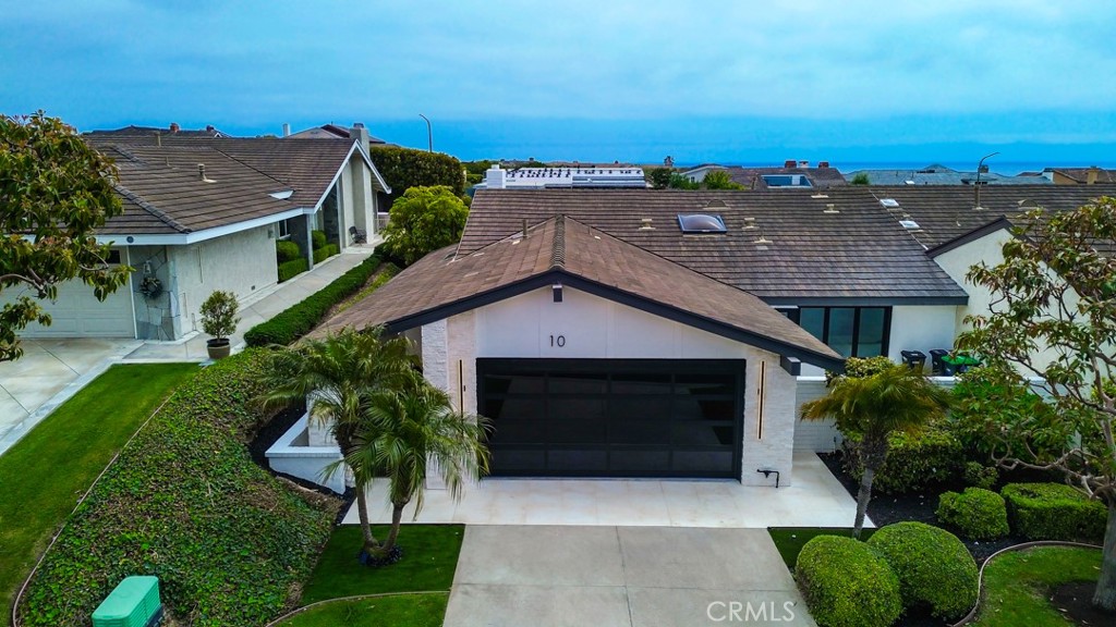 A Custom Contemporary Home in Black and White
This single-level home, encompassing over 1,900 square feet, is now available for purchase. Located in Corona del Mar, this residence provides access to resort amenities and is conveniently situated near the ocean, within the prestigious enclave of Jasmine Creek, renowned for its privacy and exclusivity.
The property boasts two bedrooms and two bathrooms, featuring a living room, entertainment room, private dining room, and a gourmet kitchen complete with a charming breakfast nook. The living room, entertainment room, and main bedroom suite all have access to the expansive rear yard, offering an exceptional indoor/outdoor living experience. The home is equipped with newer appliances and air conditioning, exemplifying quality craftsmanship throughout.
Additionally, the secondary bedroom and breakfast nook both open onto a delightful private patio. The secondary bathroom includes a custom shower and vanities with LED lighting, while the main bathroom features double vanities, a large walk-in shower, and a freestanding soaking tub. Both bathrooms are enhanced with state-of-the-art LED mirroring.
Custom stone landscaping and expansive patio space further enhance the beauty of this home, while unique windows and doors throughout create an inviting atmosphere. The walk-up deck and waterfall provide privacy and tranquility, complemented by high-quality custom lighting inside and out. The kitchen is designed for meticulous cooks, featuring a Forno 6-burner range, high-end appliances, a pantry with pull-out drawers, and custom cabinetry. The flooring is a mix of stone, tiles, and wood, adding a touch of elegance throughout. The main bedroom also boasts a spacious walk-in closet.
If you are ready to relocate, this exquisite property awaits your arrival.